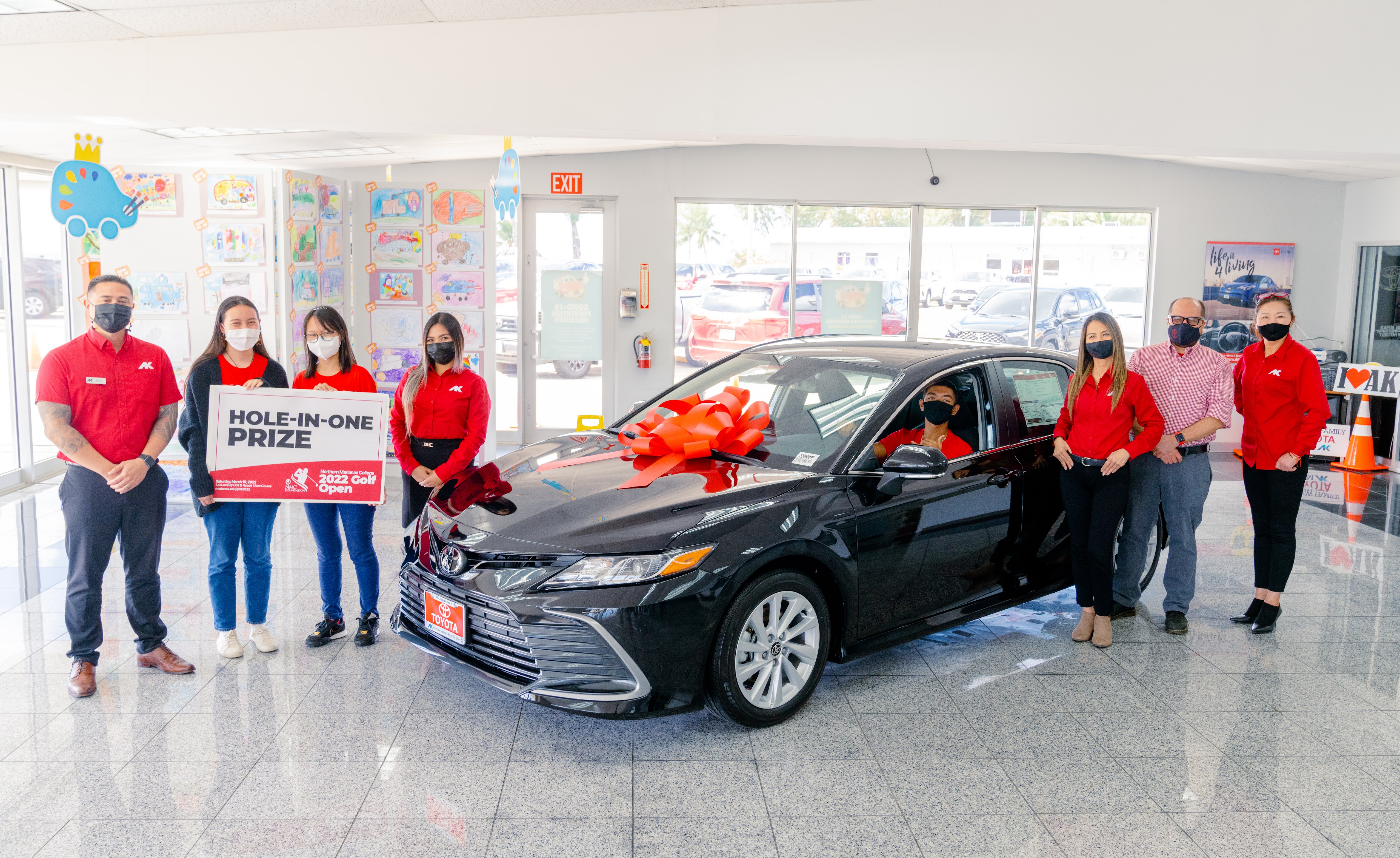 Atkins Kroll Saipan is offering a brand new 2022 Toyota Camry as a hole-in-one prize in the upcoming 17th Annual NMC Foundation Golf Tournament. In photo are NMC President Galvin Deleon Guerrero with AK Toyota sales representatives and NMC students.