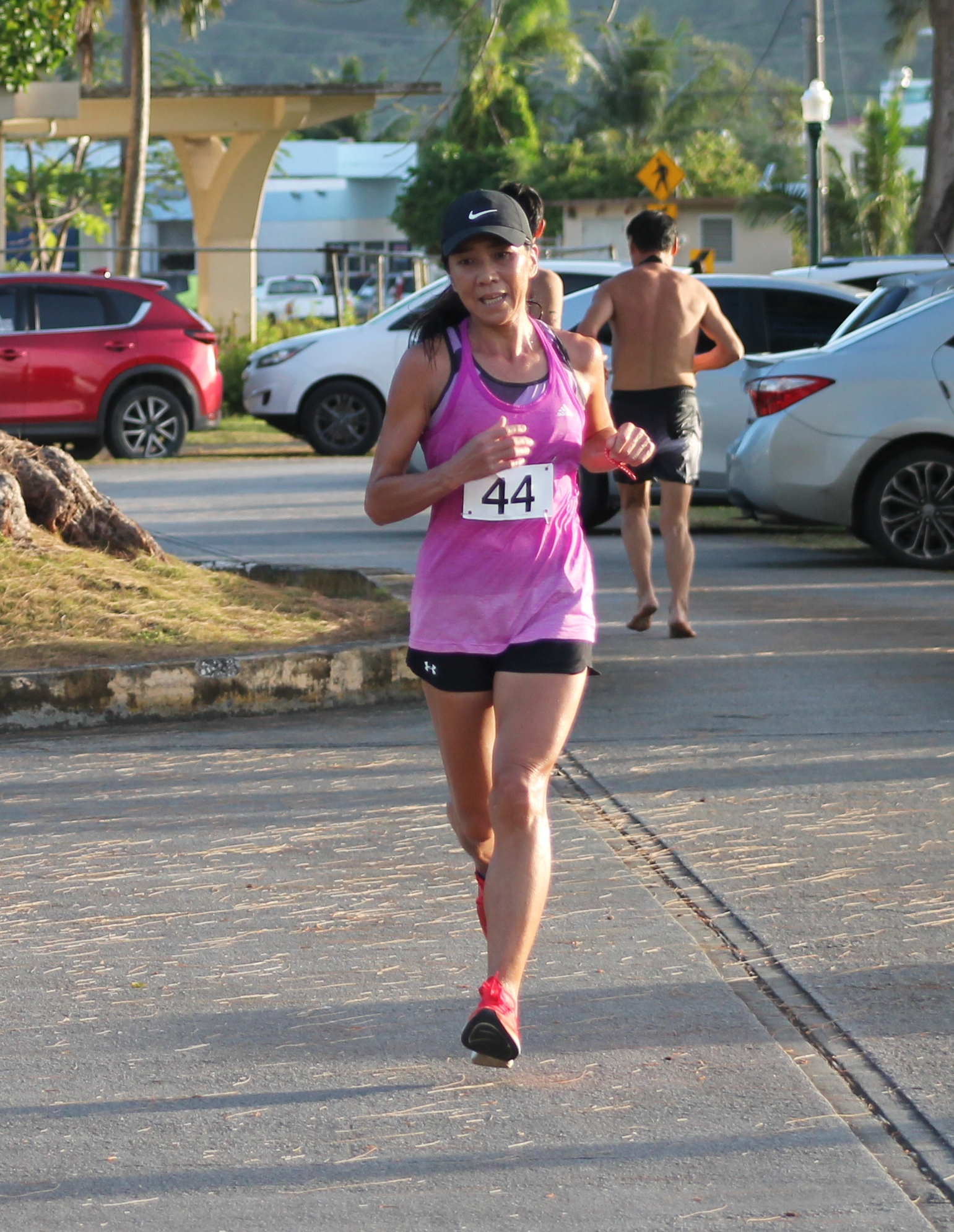 Akiko Miller pushes through the finish line to claim first place in the female division of the 10km pathway event hosted by the Triathlon Association of the CNMI Saturday at the Kilili Pavilion.