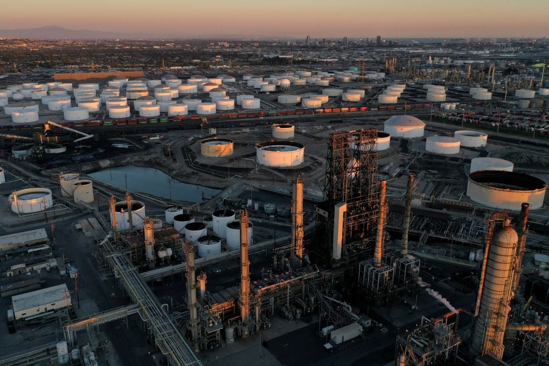 A view of the Phillips 66 Company's Los Angeles Refinery, which processes domestic & imported crude oil into gasoline, aviation and diesel fuels, and storage tanks for refined petroleum products at the Kinder Morgan Carson Terminal, at sunset in Carson, California, March 11, 2022.