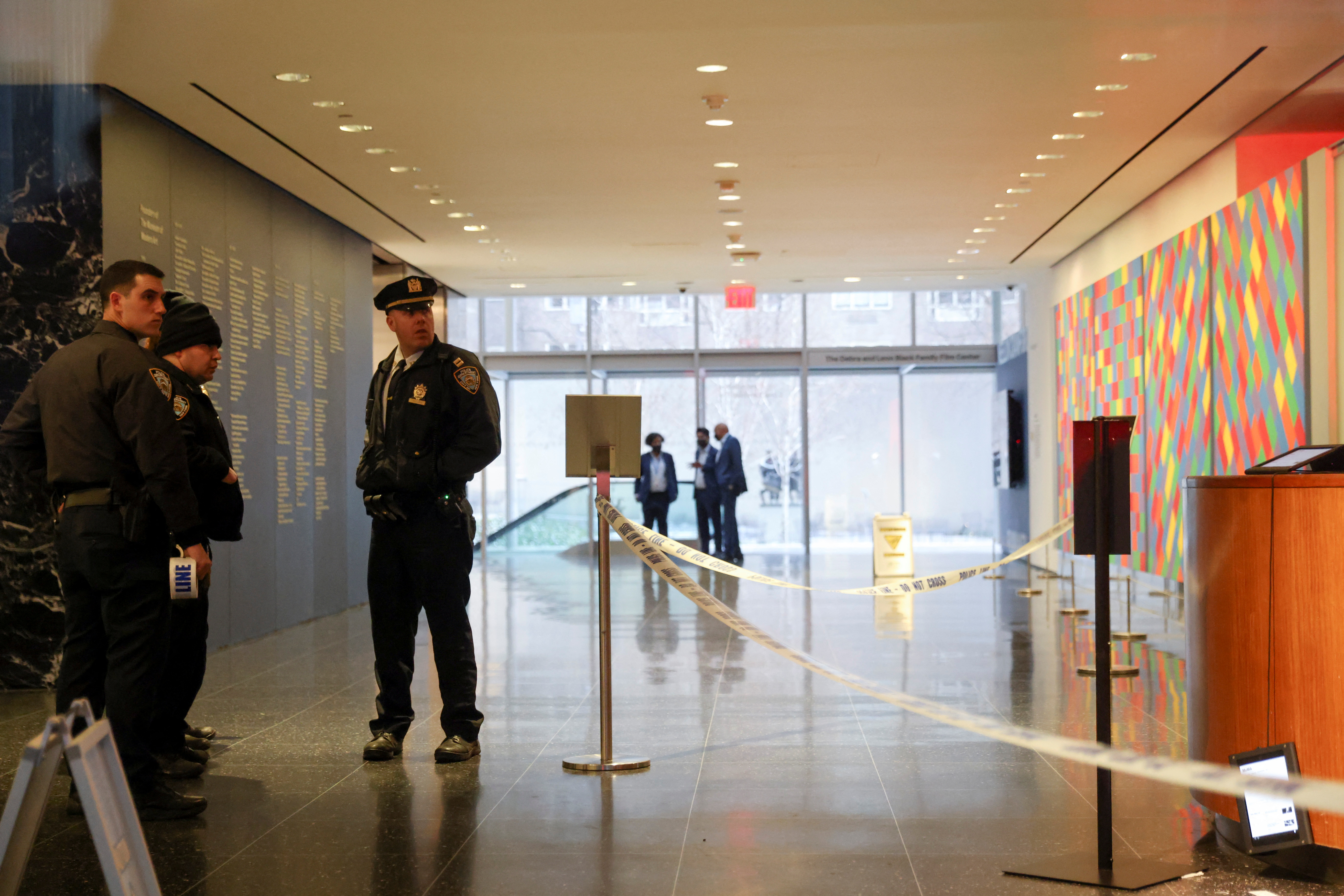 Members of the New York City Police Department gather in the lobby of the Museum of Modern Art after a multiple stabbing incident, in New York, March 12, 2022.