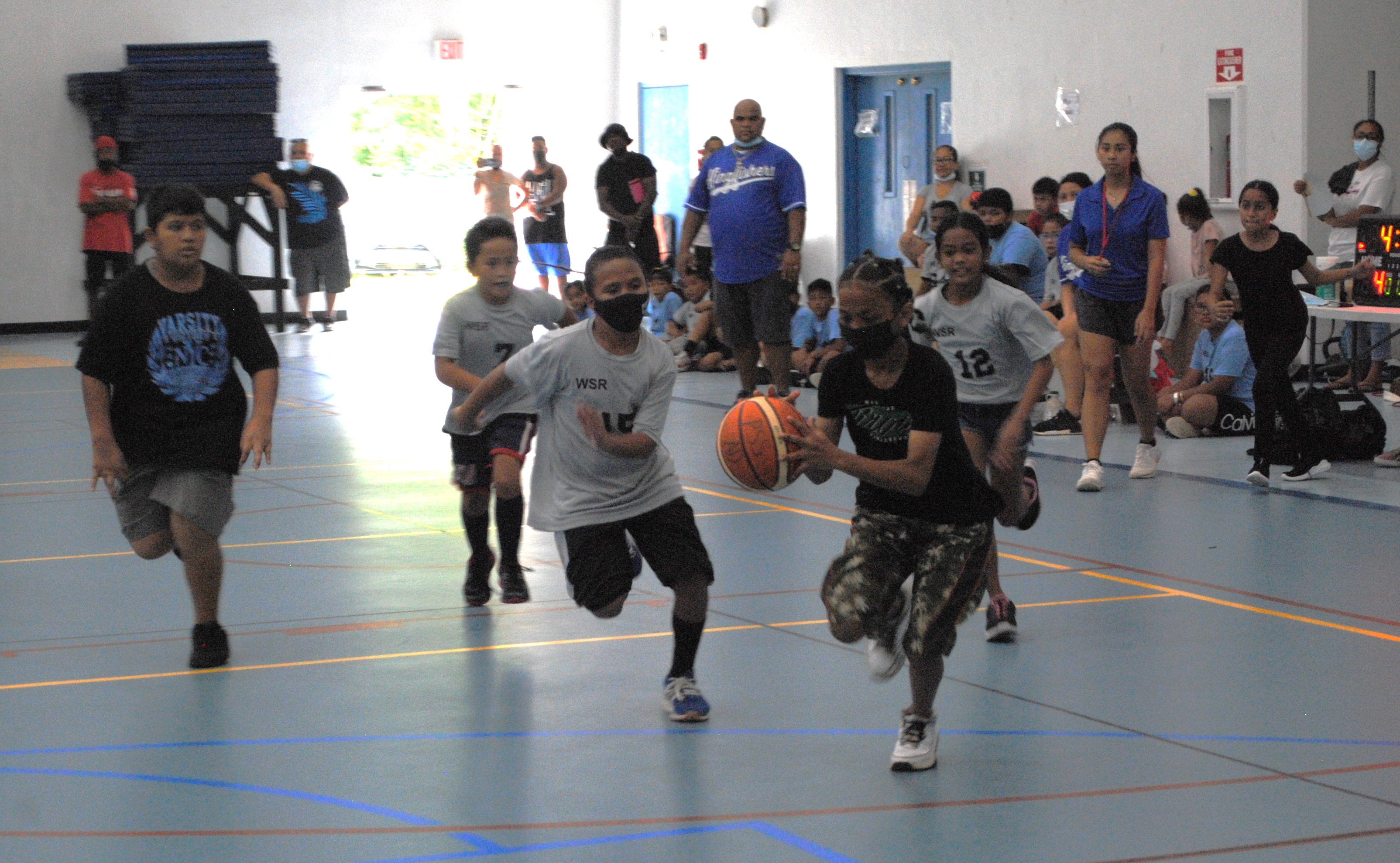 KoES 2's Kelvin John dribbles forward for an unguarded finish during an opening game of the IT&E Interscholastic Elementary Co-ed Basketball League Saturday at the MHS gym.