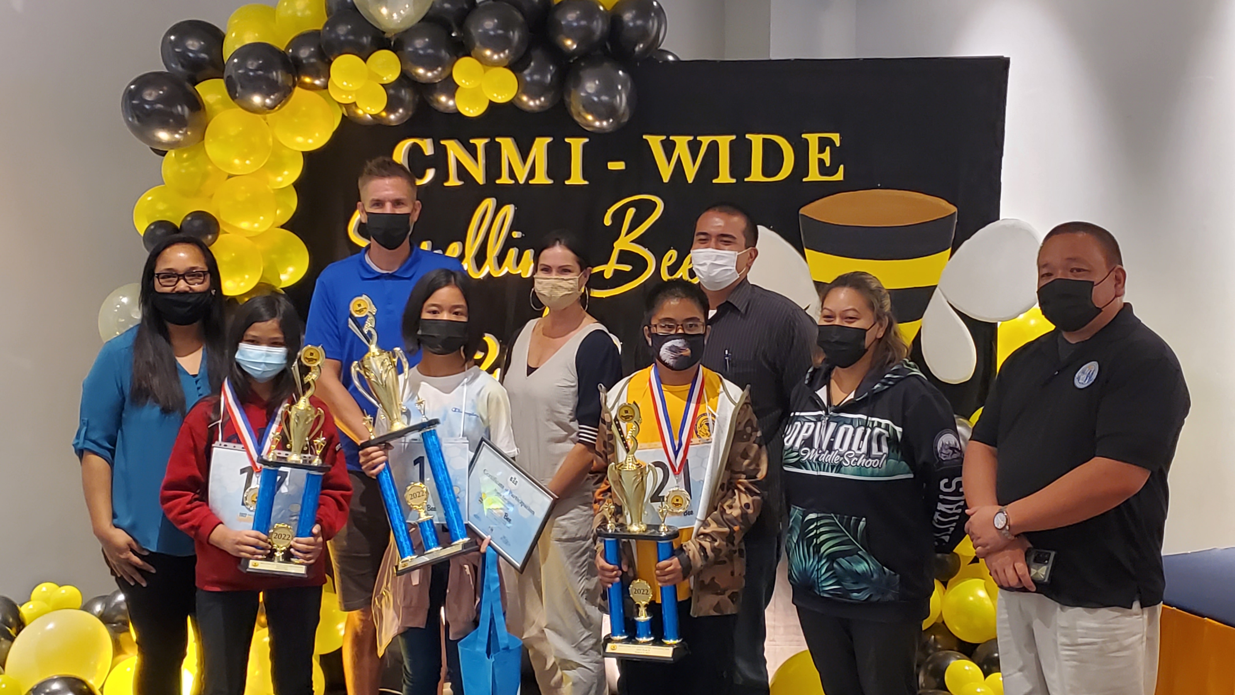 From left, Dorina Salavari, teacher; Mary Joy Viloria, 3rd placer; Peter Loken, coach; Maria Enriquez, 1st placer; Megan Nevitt-Loken, teacher; Walter Clave, 3rd placer; Jesse Sablan, coach; Karen Manuel, HMS vice principal; and Eric Magofna, associate Commissioner for Administrative Services.