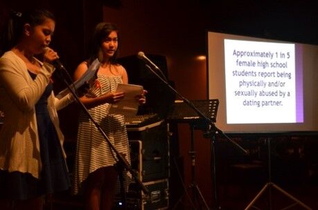 Student volunteers Eloise Lopez and Maria Theresa Dalusong emcee the 2015 Teen Poetry Slam competition at Naked Fish to raise awareness on teen dating violence. 