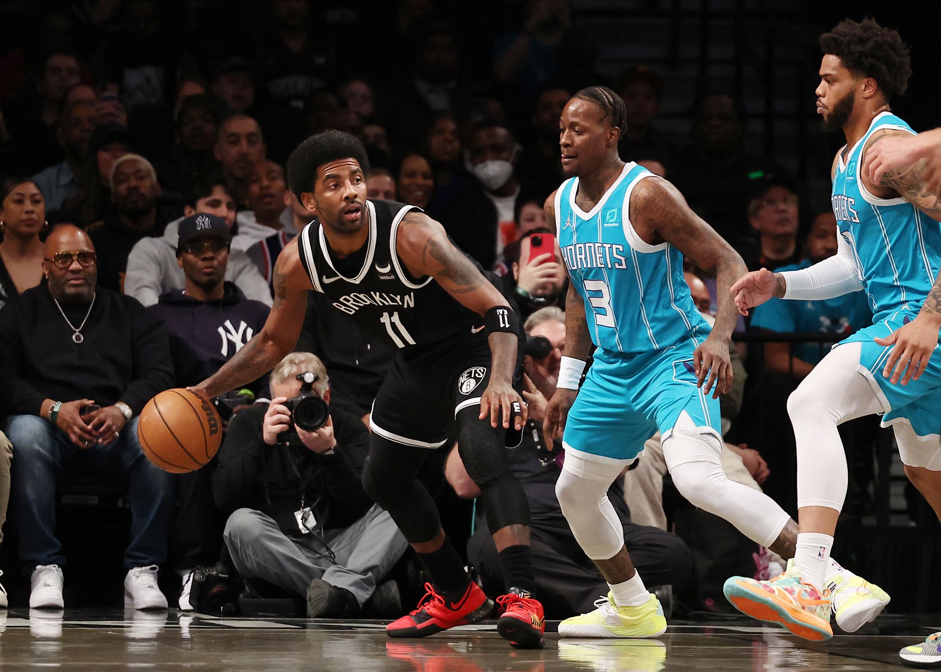 Brooklyn Nets guard Kyrie Irving (11) dribbles as Charlotte Hornets guard Terry Rozier (3) defends during the first quarter at Barclays Center in Brooklyn, New York, March 27, 2022.