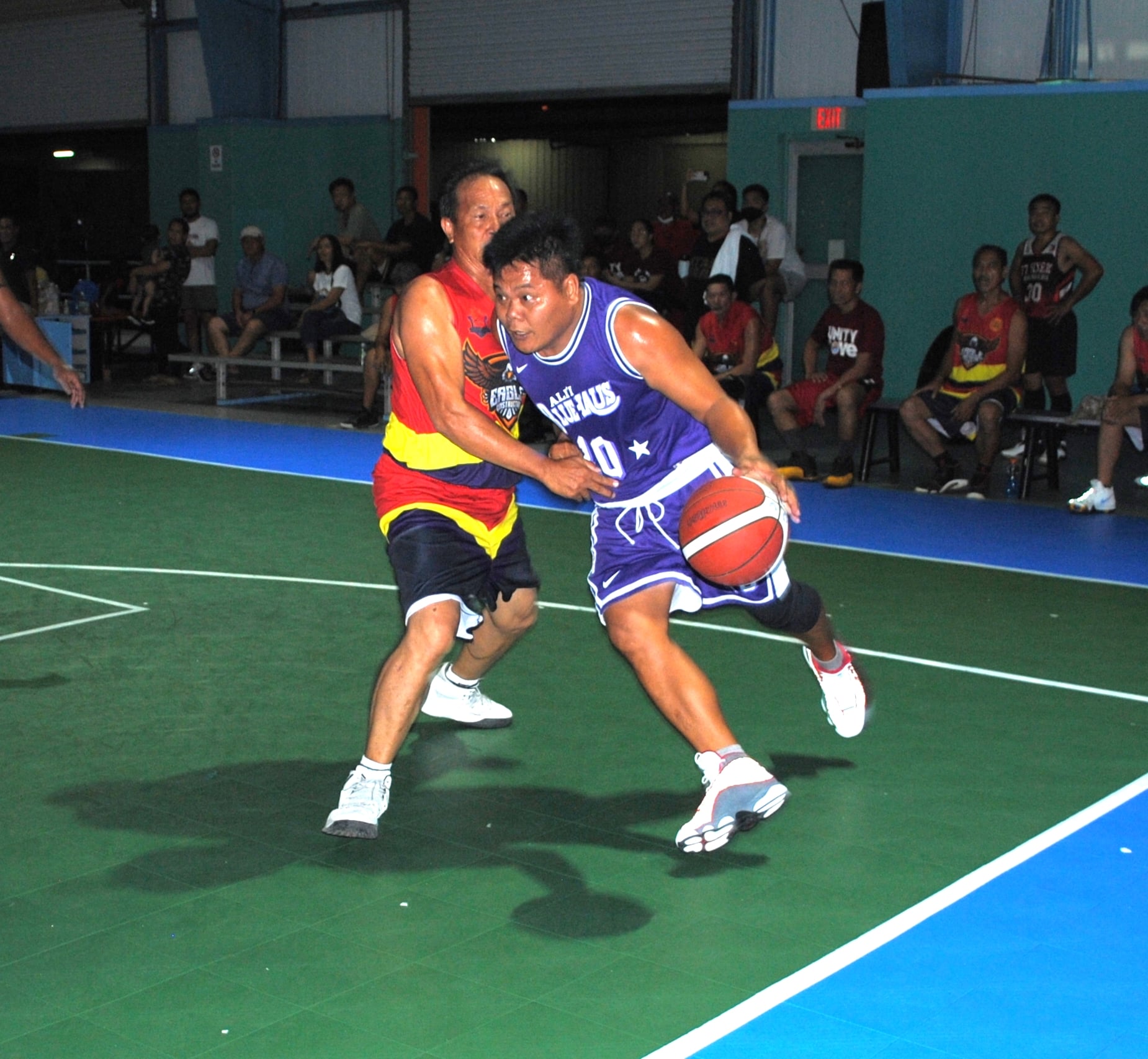 Bluehauz's Guiab slips past an Eagle Construction defender during a master's division game of the Saipan Centennial Lions Club Basketball League Saturday at the TSL Sports Complex.