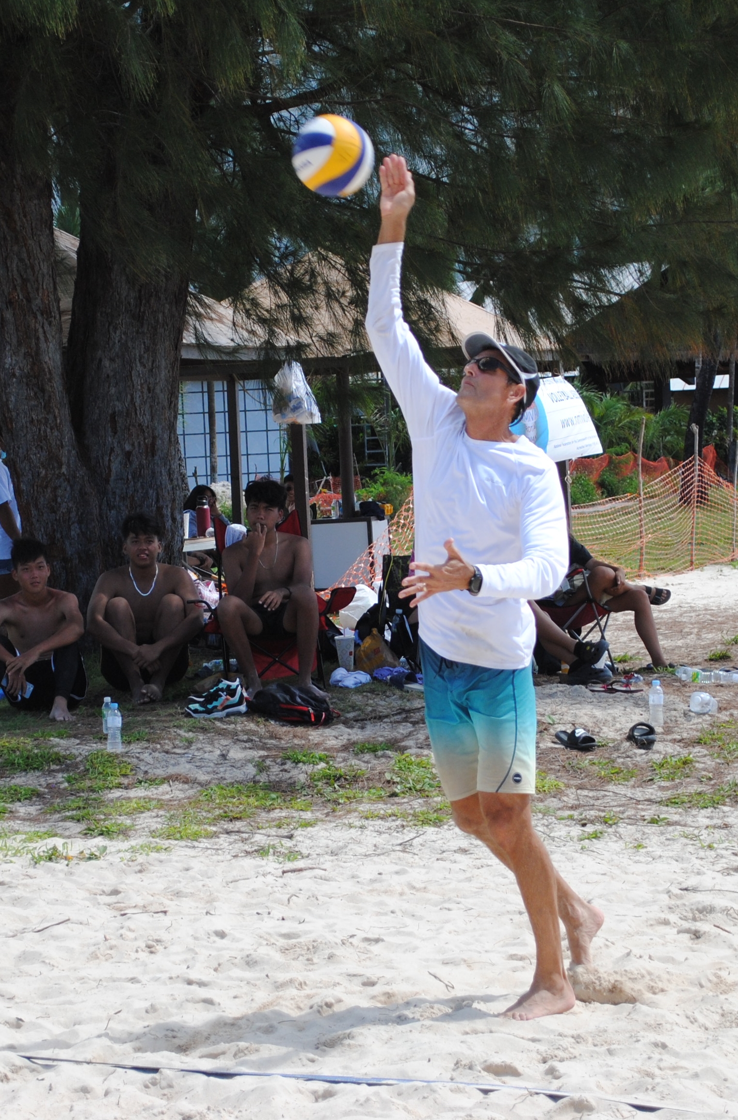 Lucky Leprechauns' Tyce Mister makes the overhead serve during a For the Luck of Volleyball game on Saturday at the Crowne Plaza beach.