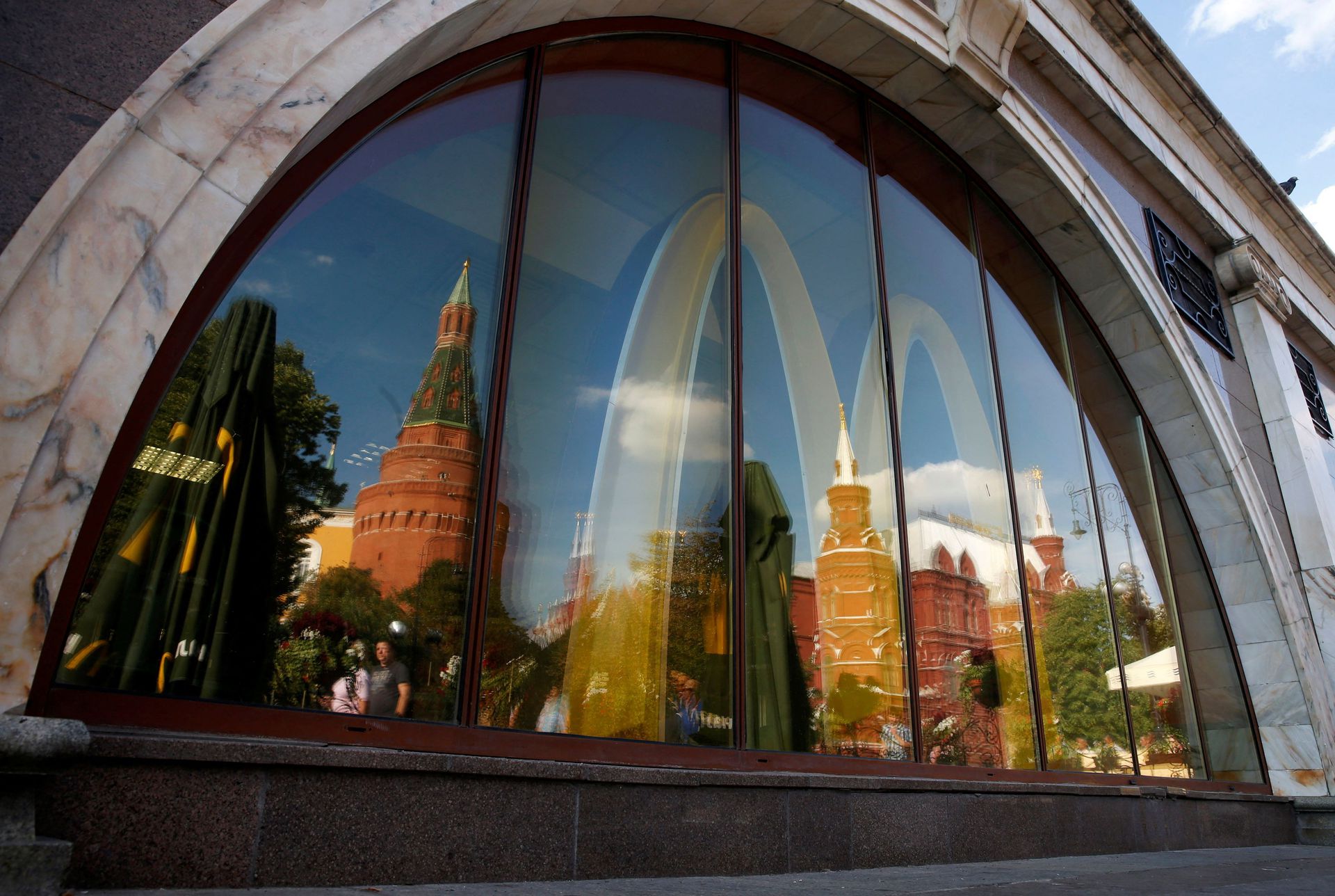 The walls and towers of the Kremlin are reflected in a window of a closed McDonald's restaurant in Moscow, Aug. 21, 2014.