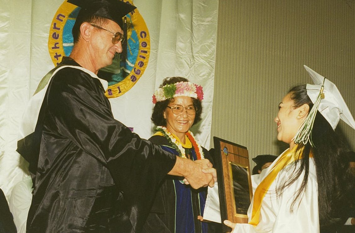 Educator Ivan Propst congratulates a Northern Marianas College graduate. With him is then-NMC President Agnes M. McPhetres.