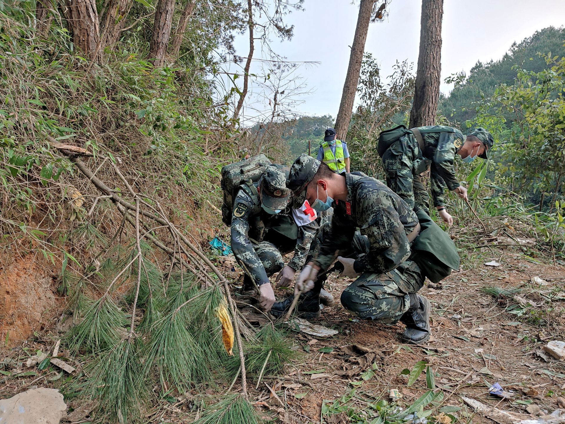 Paramilitary police officers work at the site where a China Eastern Airlines Boeing 737-800 plane flying from Kunming to Guangzhou crashed, in Wuzhou, Guangxi Zhuang Autonomous Region, China on March 21, 2022.