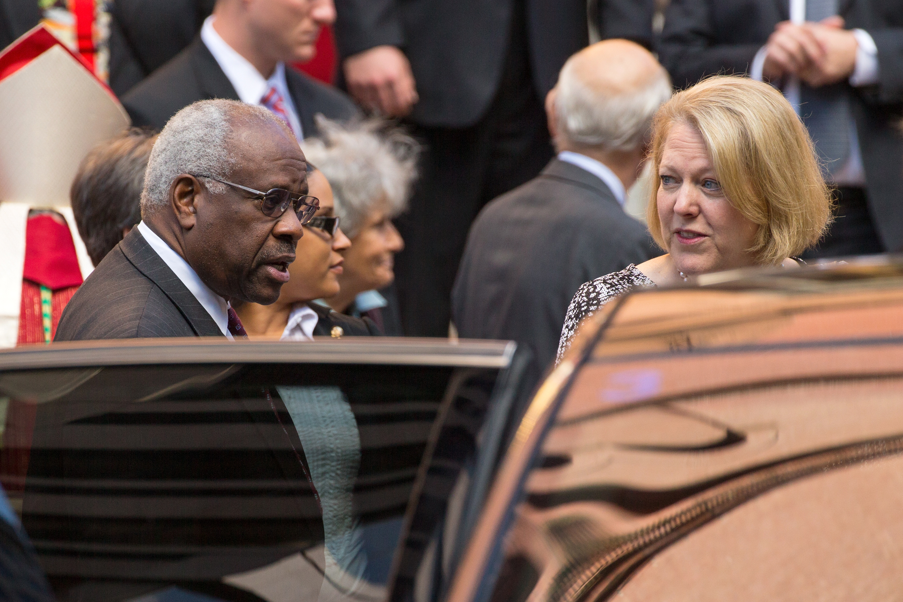U.S. Supreme Court Justice Clarence Thomas and his wife Virginia Thomas exit following the Red Mass, a service to mark the beginning of this year's Supreme Court term, at the Cathedral of St. Matthew the Apostle in Washington, D.C. on Oct. 5, 2014.