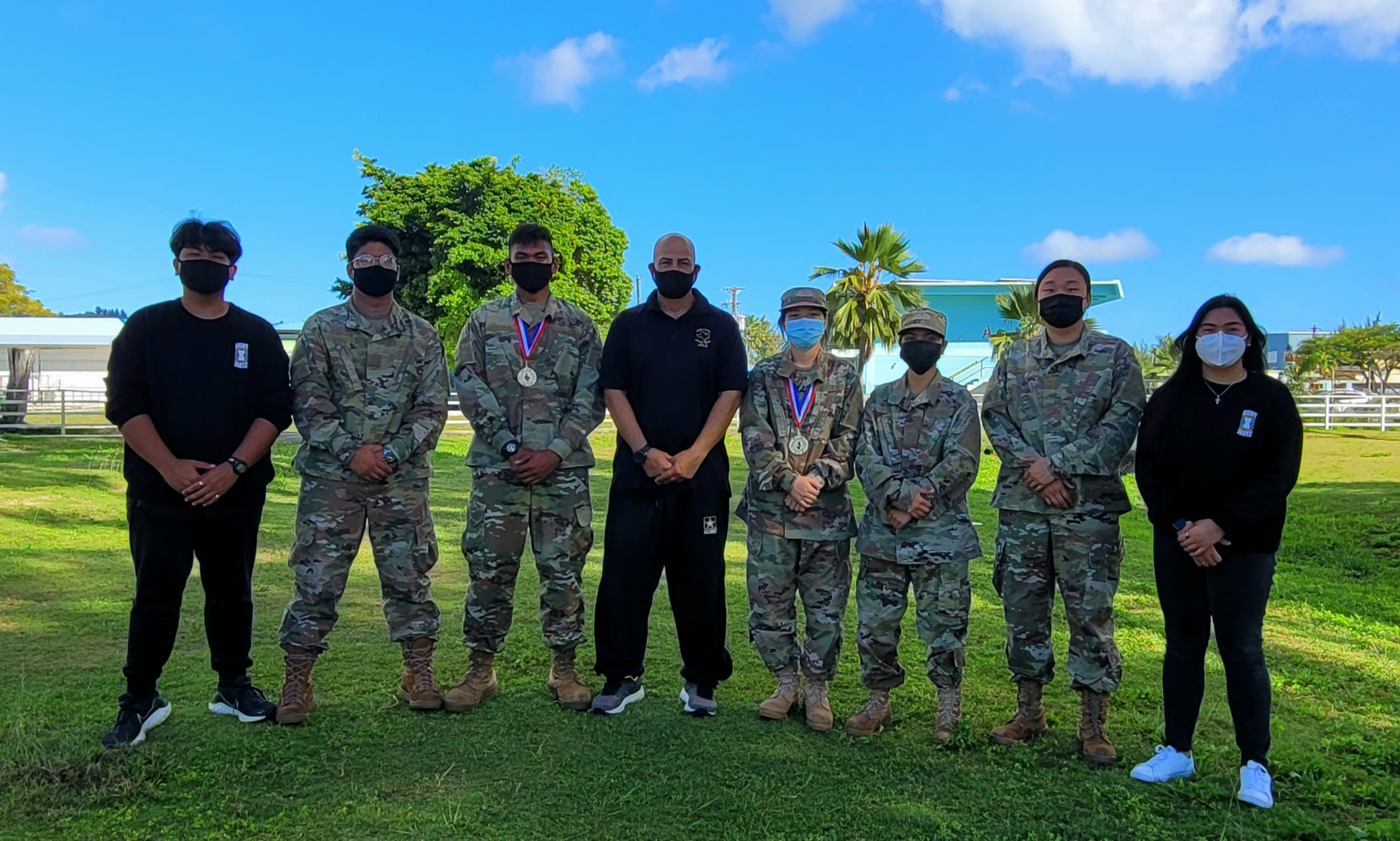 From left, C/CSM Vince Silva, C/SFC Marl Balignasay, C/MAJ Teody Valenzuela, SFC Albert Lujan, C/SGT Jenny Lin, C/2LT Ramona Camacho, C/CPT Evelyn Liu, and C/LTC Jaibelle Nelmida pose for a group photo at Marianas High School.