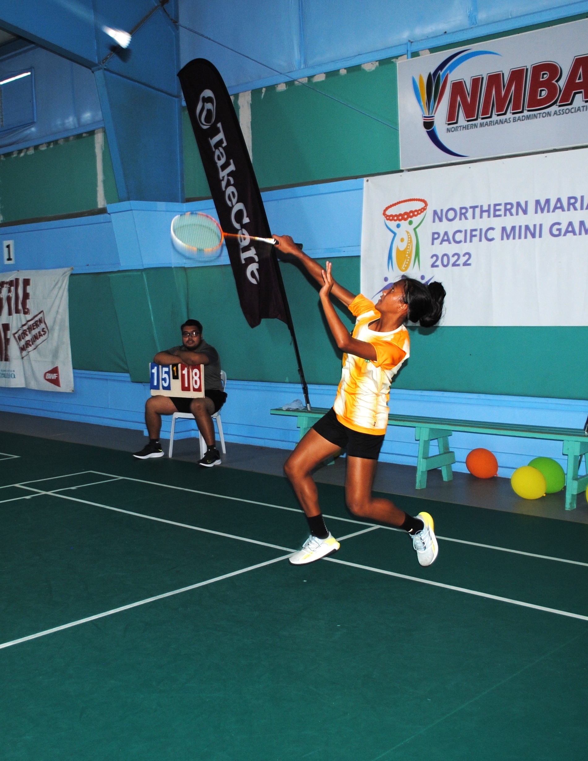 SIS' Kaithlyn Chavez connects the high return shot during the high school division championship game of the TakeCare Interscholastic Badminton League on Saturday at TSL Sports Complex.