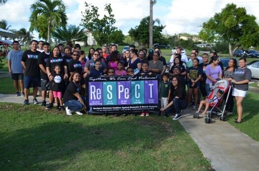 Northern Marianas College students, faculty, and staff take part in their campus Silent Walk Against Domestic Violence in October 2016. 