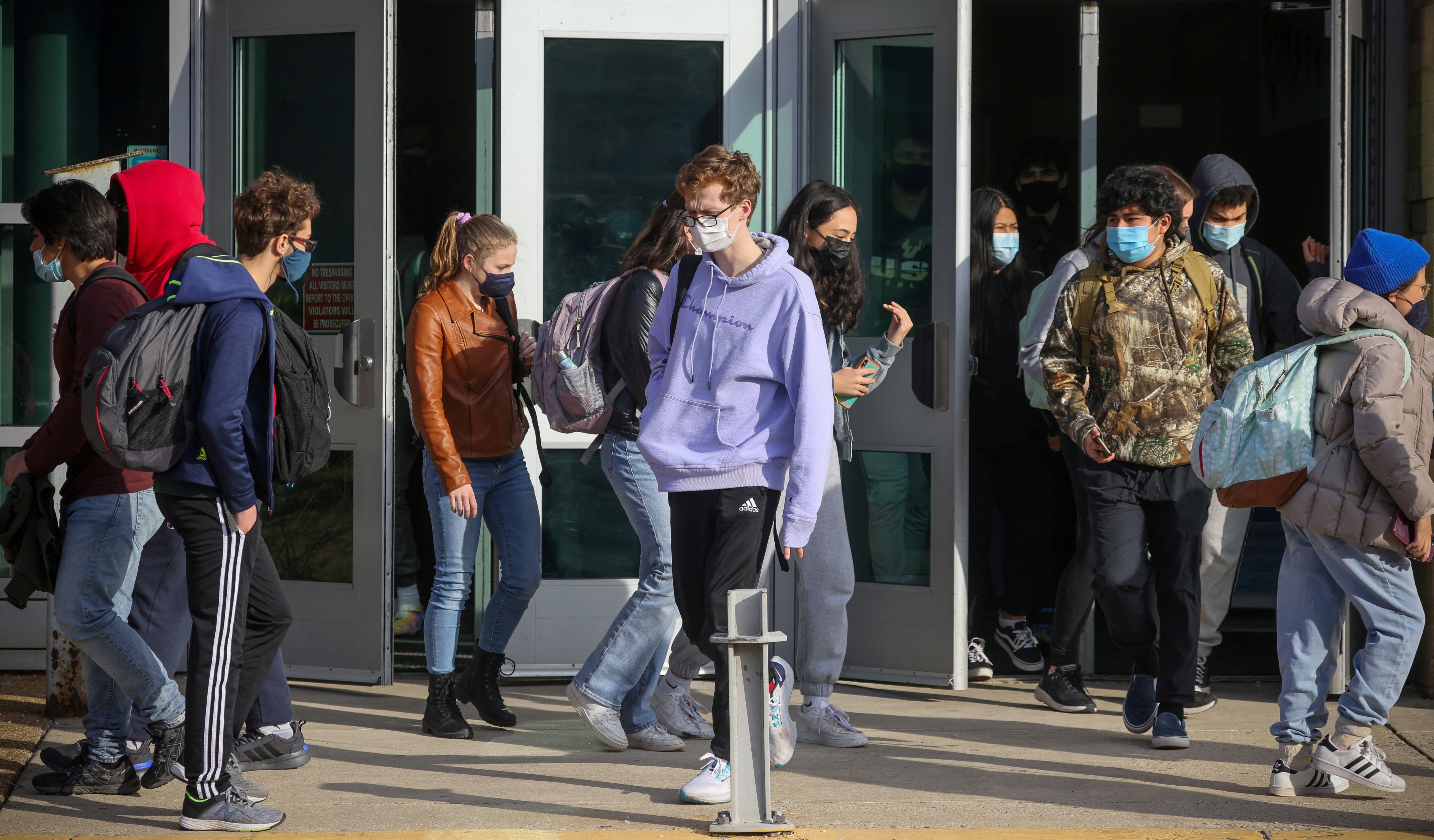 Students leave Washington-Liberty High School in Arlington County which is one of several school districts that sued to stop the mask-optional order by Gov. Glenn Youngkin in Arlington, Virginia on Jan. 25, 2022.
