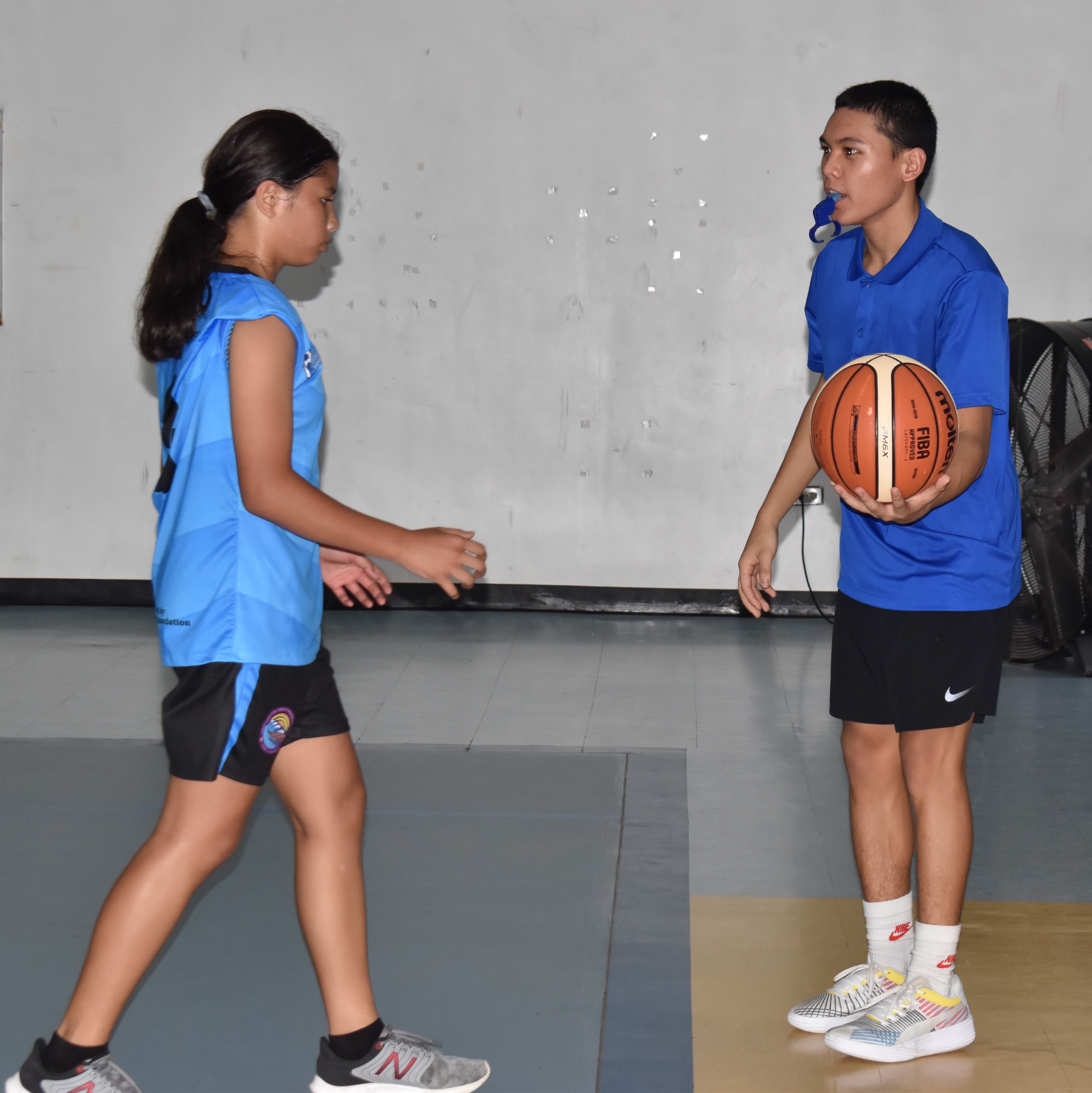 Kyu Aldan, right, waits for the Francisco M. Sablan Middle School player in the sideline for the inbound play during a game in the IT&E Interscholastic Girls Middle School Basketball League late last year at the Marianas High School Gymnasium.