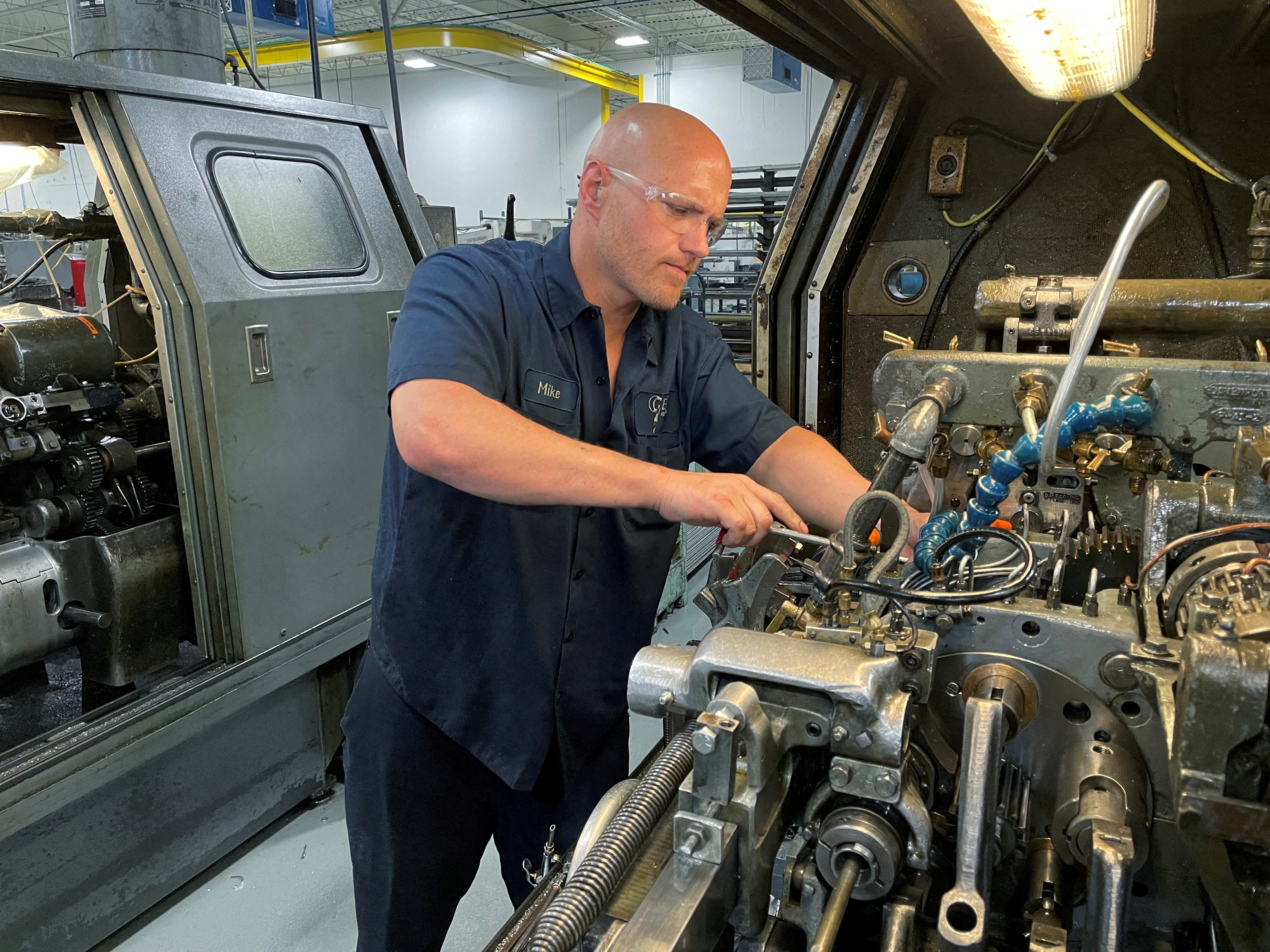 A worker operates one of the metal cutting machines at Gent Machine Co.'s factory in Cleveland, Ohio,  May 26, 2021.