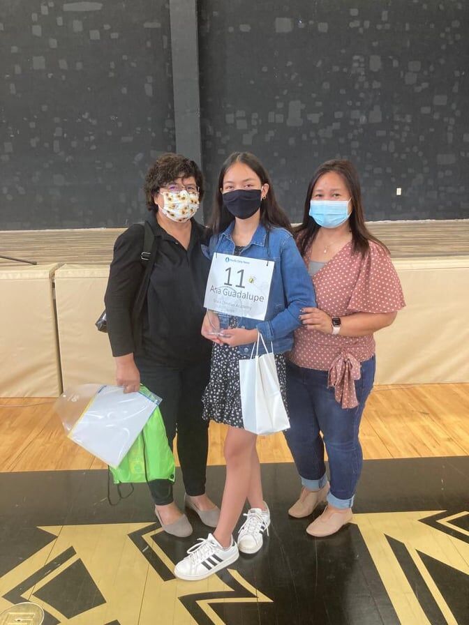Grace Christian Academy's Ana Guadalupe Villagomez poses for a photo with Public School System Senior Director Jackie Quitugua and Ana's teacher-coach, Grace Duran, after the seventh grader won the 2022 Scripps Regional Spelling Bee on Guam.