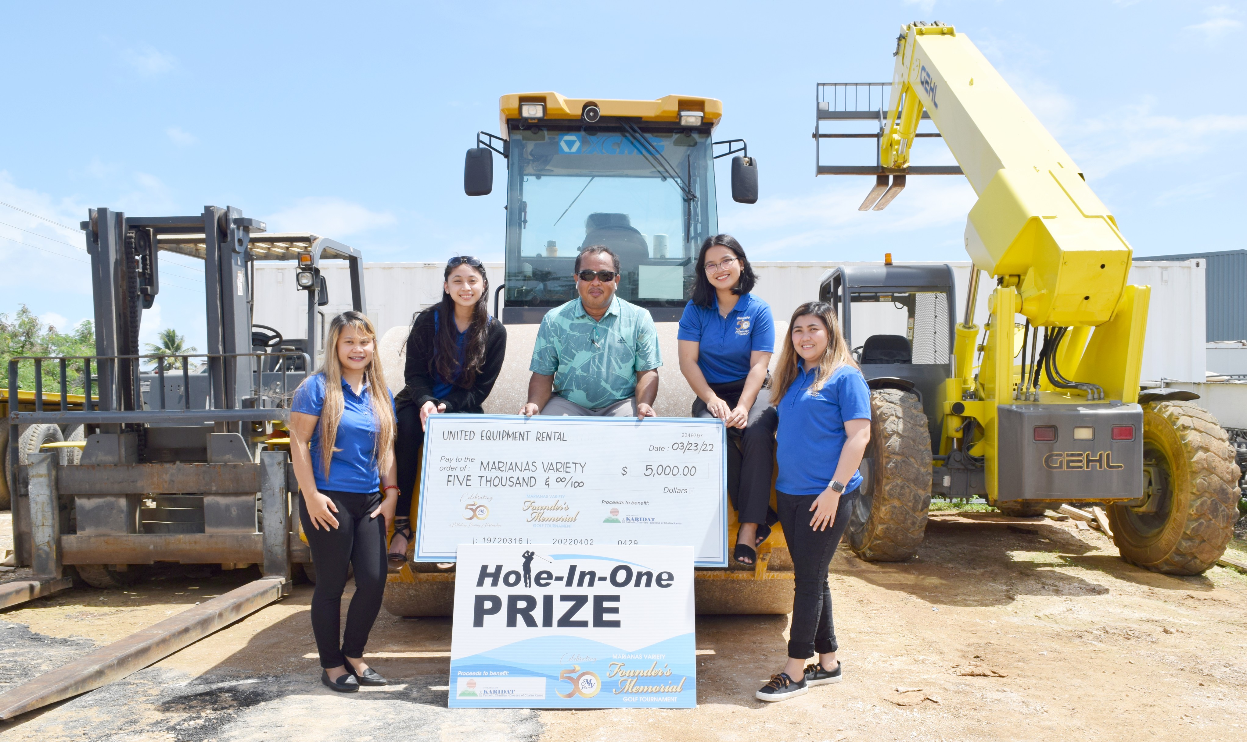 United Equipment Rental owner Rene Batallones, center, holds a ceremonial check for $5,000 which his company donated as a hole-in-one prize in the MV Founder's Memorial Golf Tournament set for Saturday, April 2 at 6 a.m., LaoLao Bay Golf & Resort, West Course. The event aims to raise funds for the charitable organization Karidat. Also in photo are Marianas Variety sales representatives Diane Lumapas, Monique Mascarinas, Hazel Sadian and Gwendolyn Sandig.