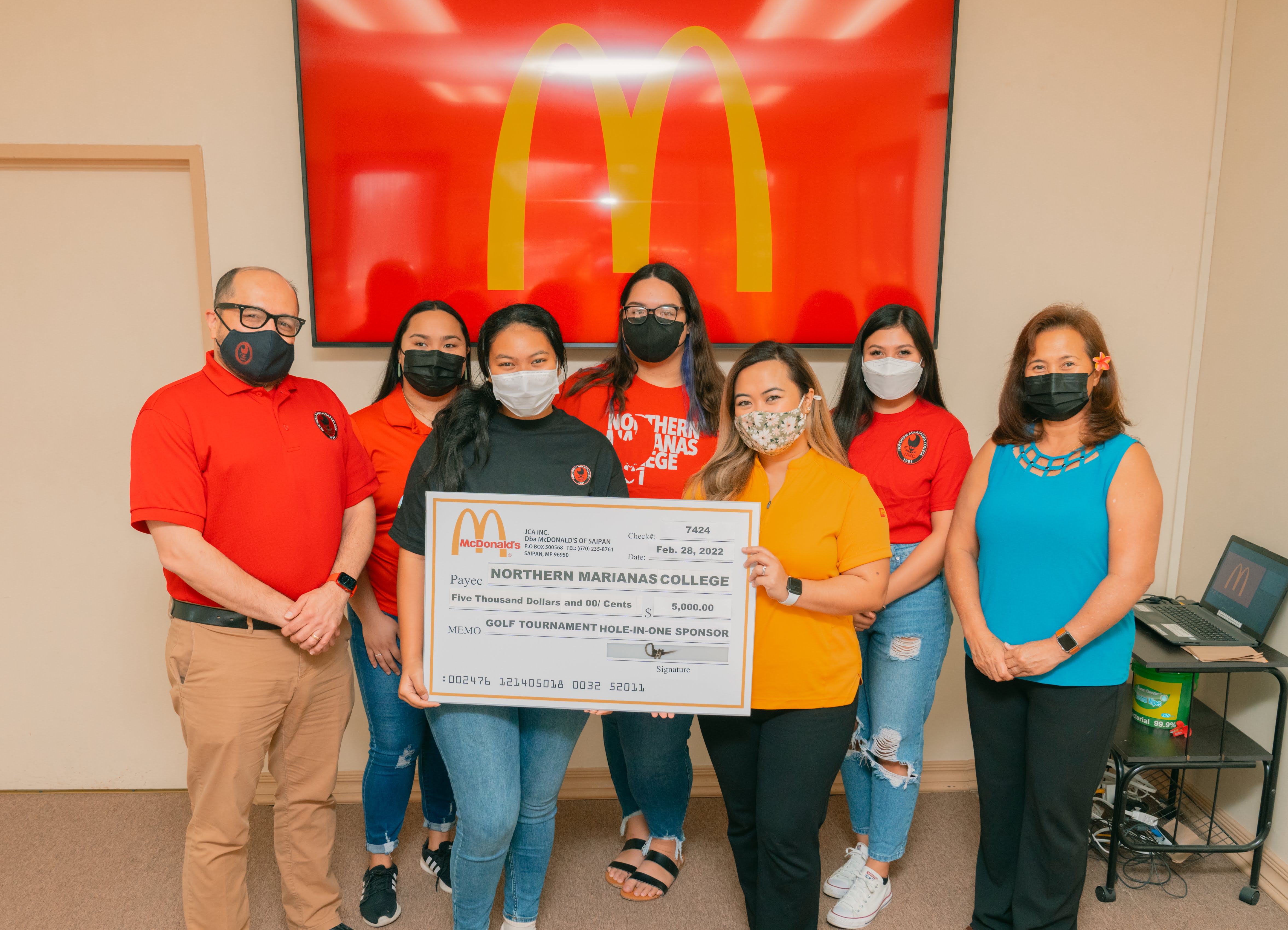 Northern Marianas College President Galvin Deleon Guerrero, EdD, left, poses with McDonald’s of Saipan and Guam vice president and owner/operator Marcia Ayuyu, right, executive assistant to the president Mable A. Glenn, and other NMC representatives at the McDonald's main office on Monday during the presentation of a check for $5,000 — McDonald’s hole-in-one prize donation to the  NMC Golf Open.