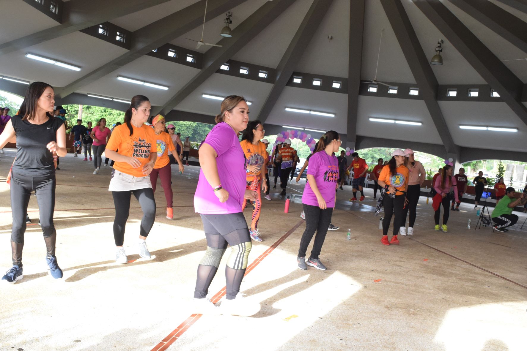 Saipan Maga'Haga Lady Eagles Club President Angelica Vina Lastimado and other participants perform a Zumba workout at the Garapan roundhouse on Saturday.