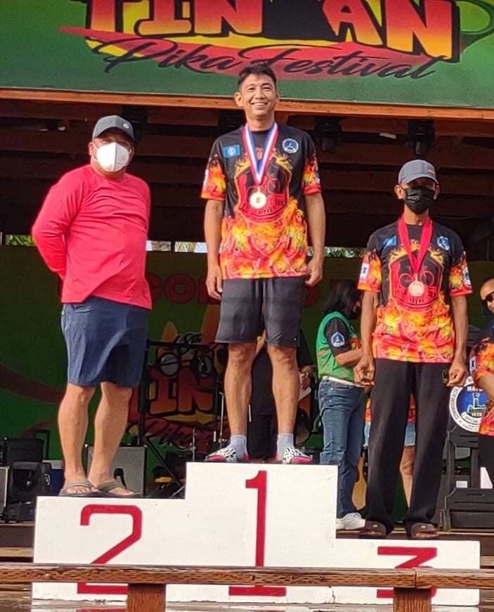 Tinian Mayor Edwin P. Aldan poses, left, poses for a photo with Rodelo Lagunay, center, who won the gold in the 7th Annual Pika Bike Race on Saturday.