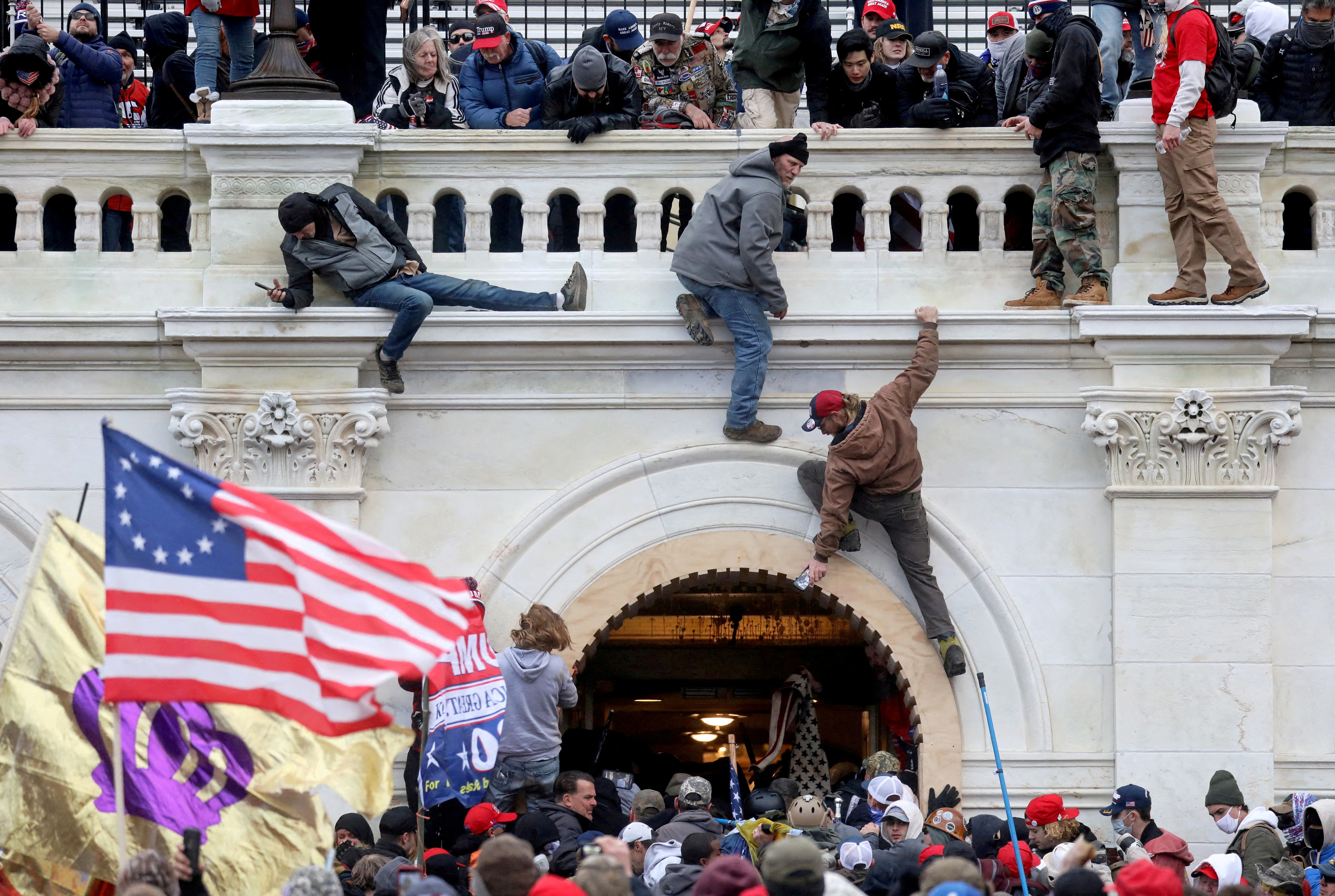 A mob of supporters of  President Donald Trump fight with members of law enforcement at a door they broke open as they storm the U.S. Capitol in Washington, D.C., Jan. 6, 2021.