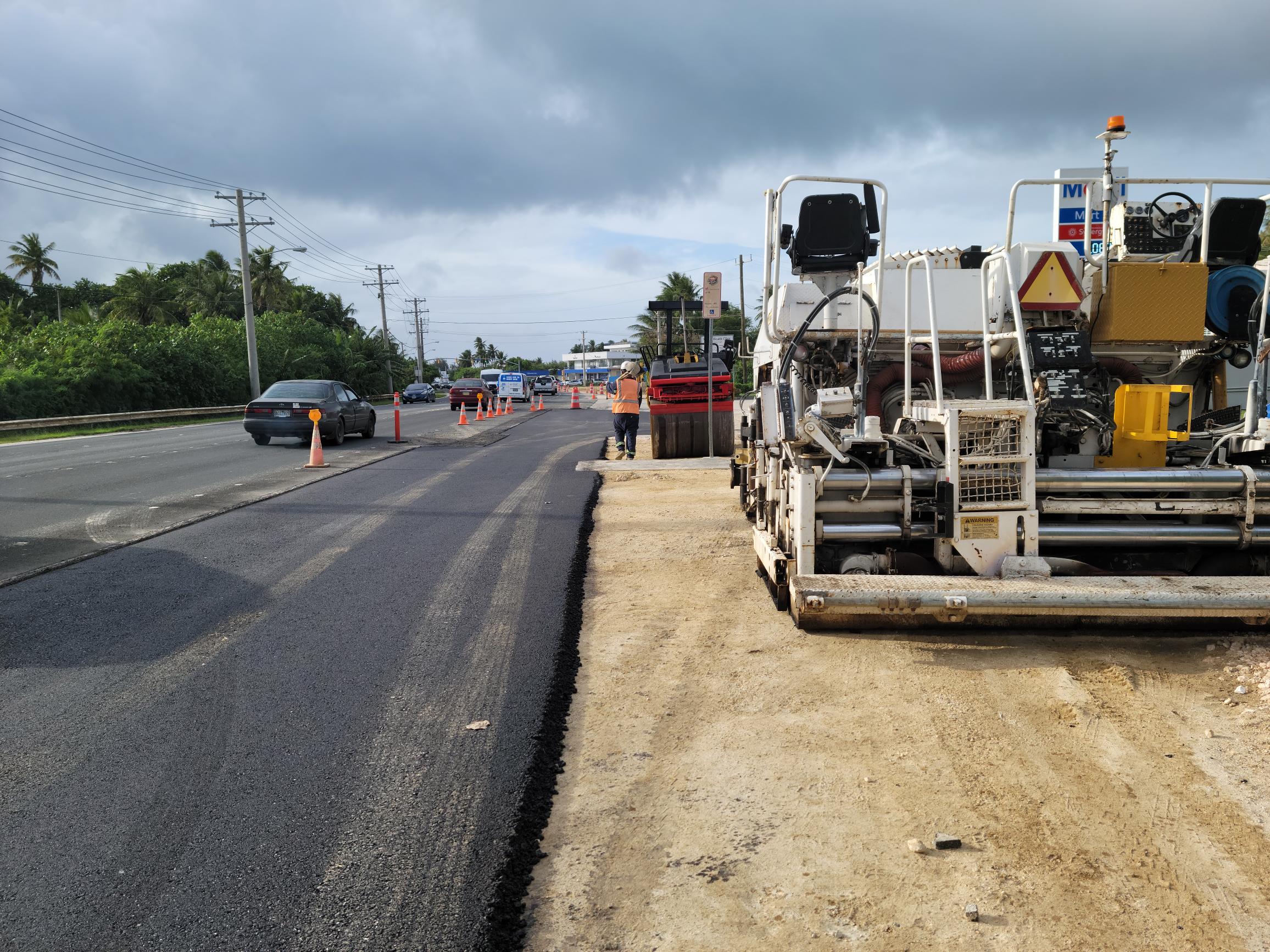 An asphalt paver is seen on the side of the road near the Chalan Kiya  W-6 sewer project site.