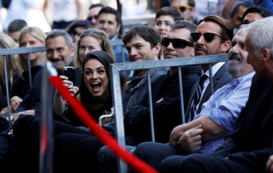 Mila Kunis and Ashton Kutcher sit in the audience during the ceremony for the unveiling of Zoe Saldana's star on the Hollywood Walk of Fame in Los Angeles, California on May 3, 2018.