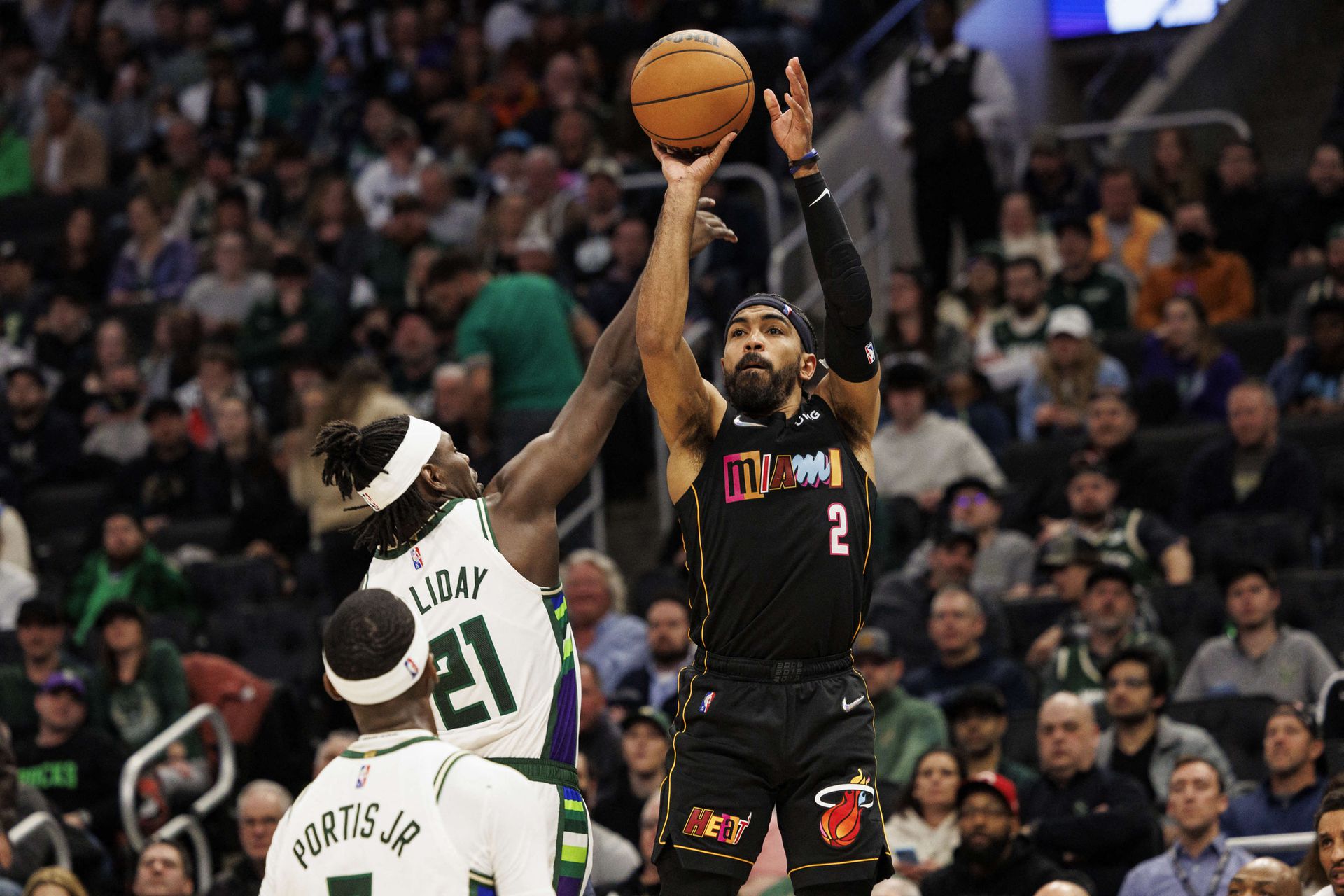 Miami Heat guard Gabe Vincent (2) shoots against Milwaukee Bucks guard Jrue Holiday (21) during the fourth quarter at Fiserv Forum in Milwaukee, Wisconsin on March 2, 2022.