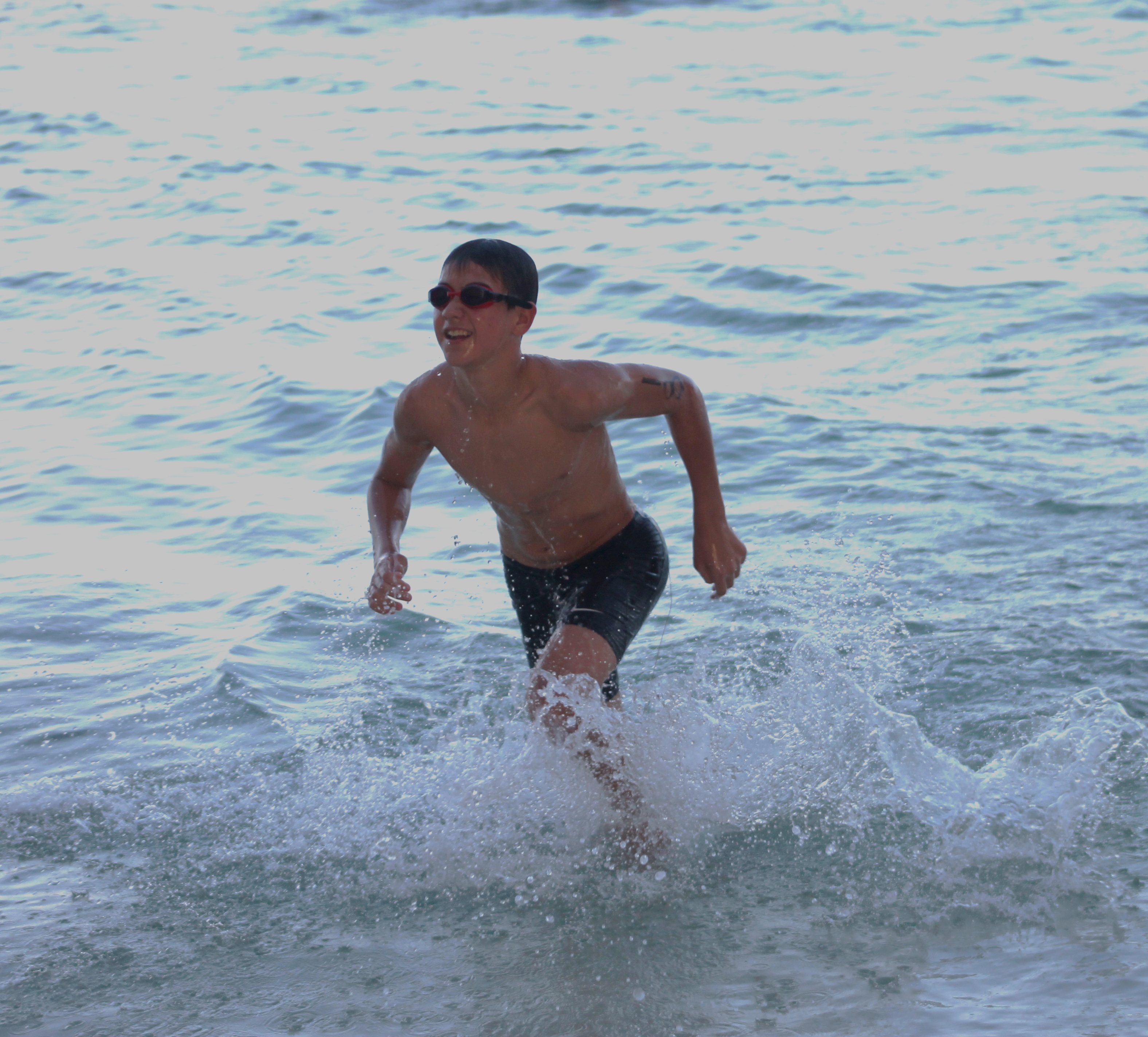Michael Miller rushes out of the water after completing the swim portion of the 7th Aquathon. 