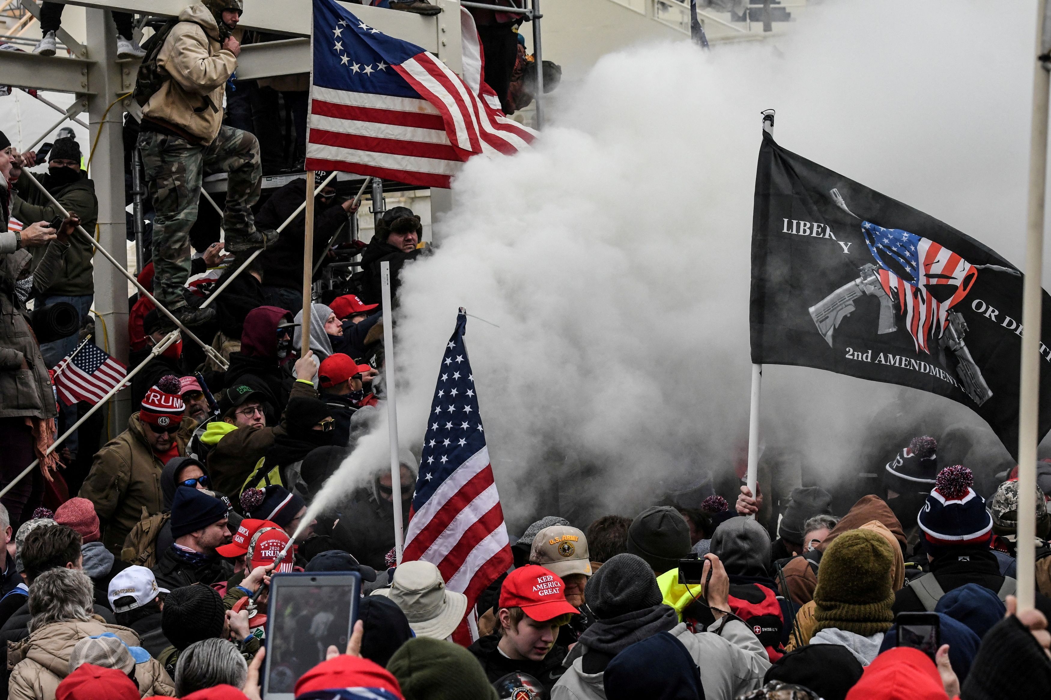 A supporter of President Donald Trump sprays smoke during a "Stop the Steal" protest outside of the Capitol in Washington, D.C. on Jan. 6, 2021.