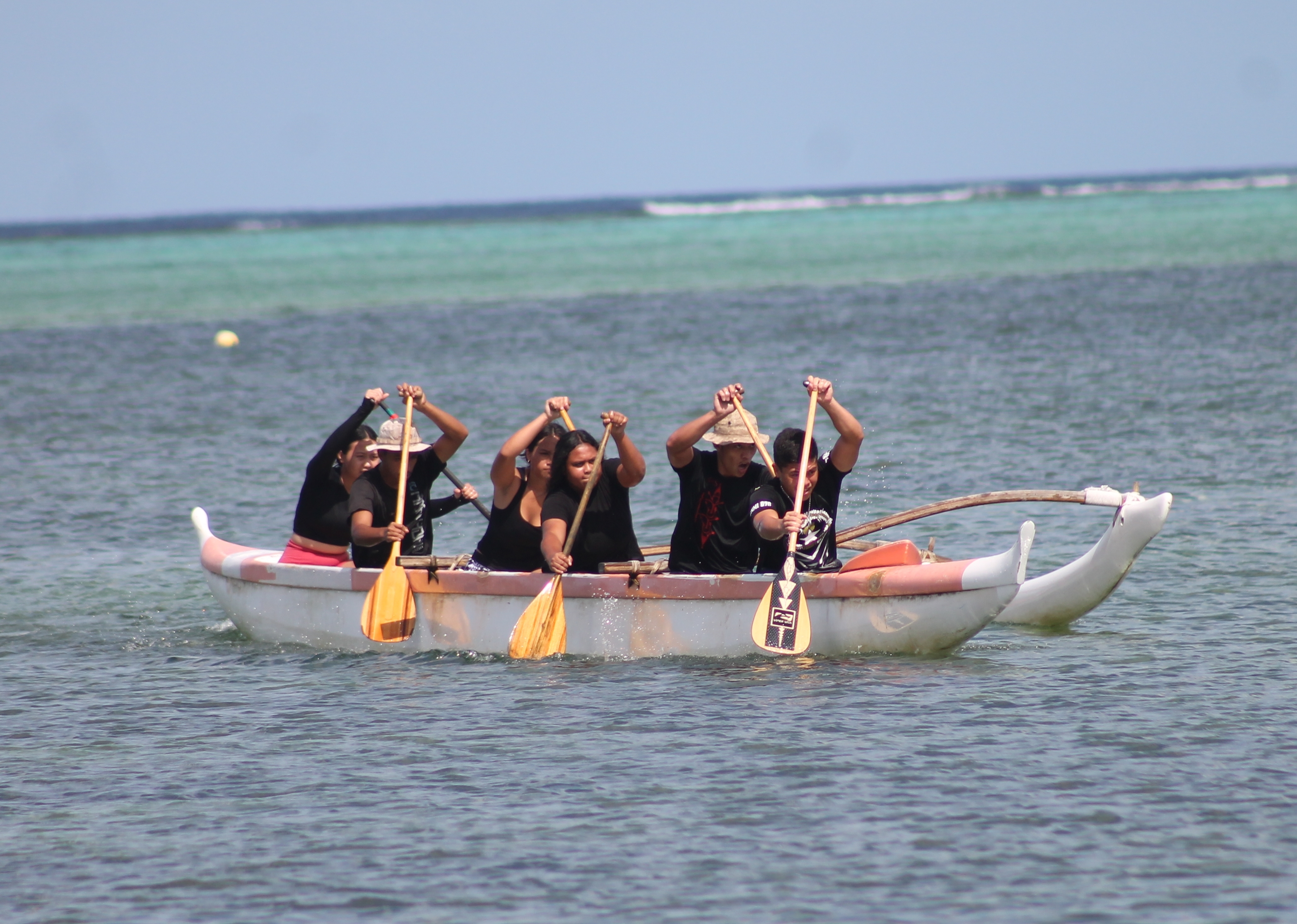 Kagman High School’s co-ed team members work in sync during  a PSS Co-ed Outrigger race Saturday at Kilili Beach.