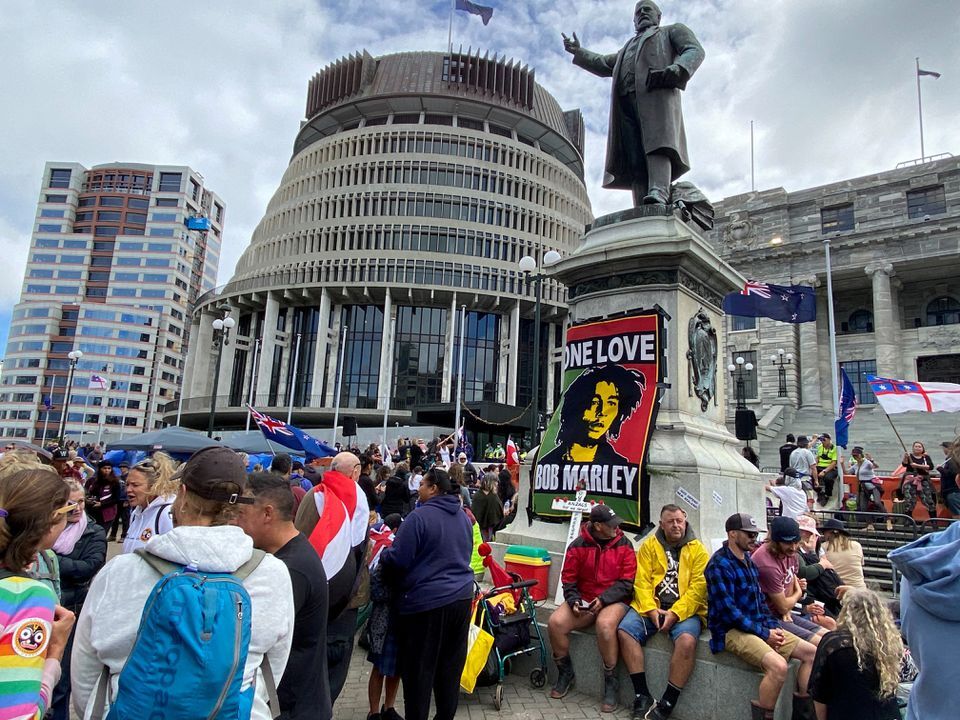 Protesters against the coronavirus disease restrictions and vaccine mandates gather as they camp in front of the parliament in Wellington, New Zealand, Feb. 14, 2022.