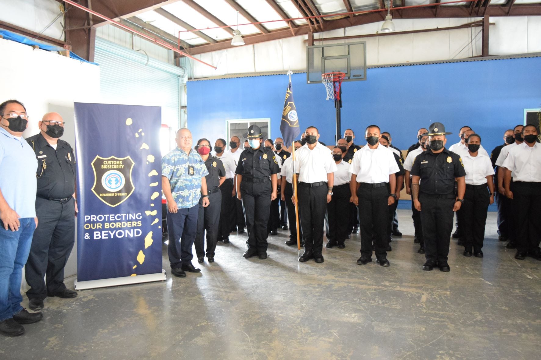 Customs and Quarantine Director Jose Mafnas, third left, Northern Marianas College Criminal Justice Department chair Clement R. Bermudes, left, Special Assistant for Customs Enforcement Col. James C. Deleon Guerrero, second left, and Customs Capt. Reina Camacho join the First Cycle cadets of the Customs and Biosecurity Academy at the Customs Seaport Warehouse on Monday.