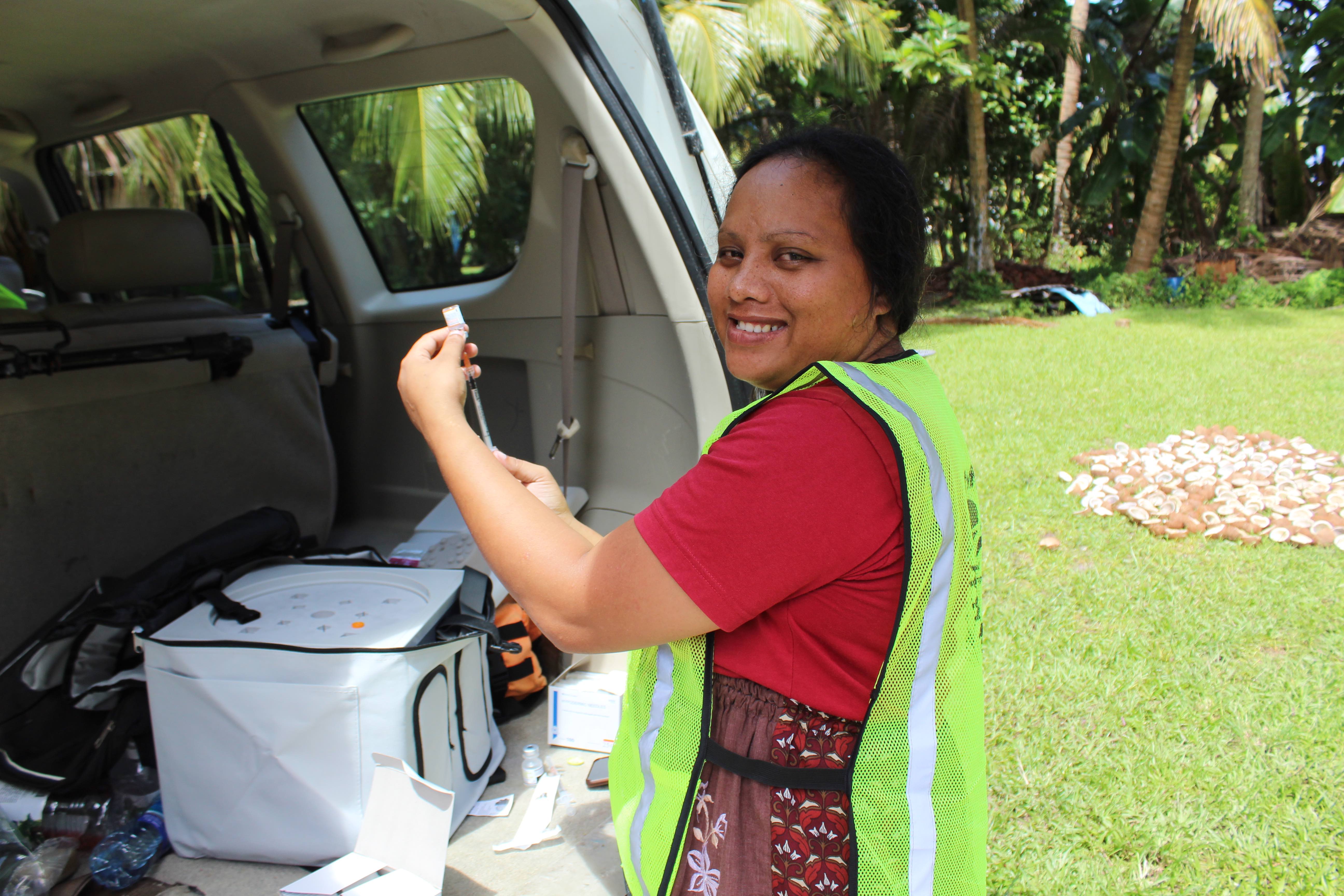 Public Health nurse Shimiko Thomas prepares Covid shots during a recent house-to-house vaccination campaign by the Ministry of Health and Human Services.