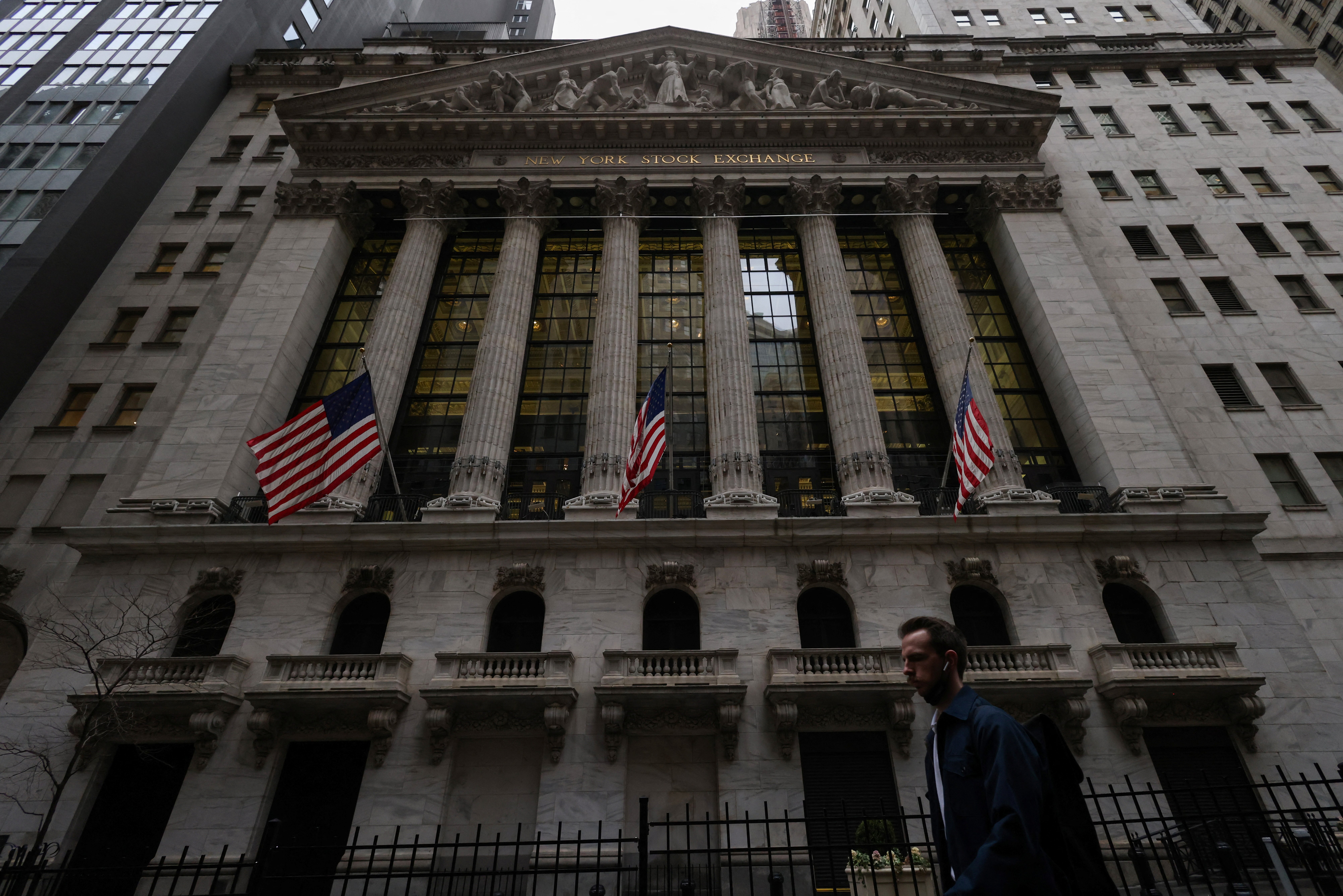 A person walks past the New York Stock Exchange in Manhattan, New York City, March 7, 2022.