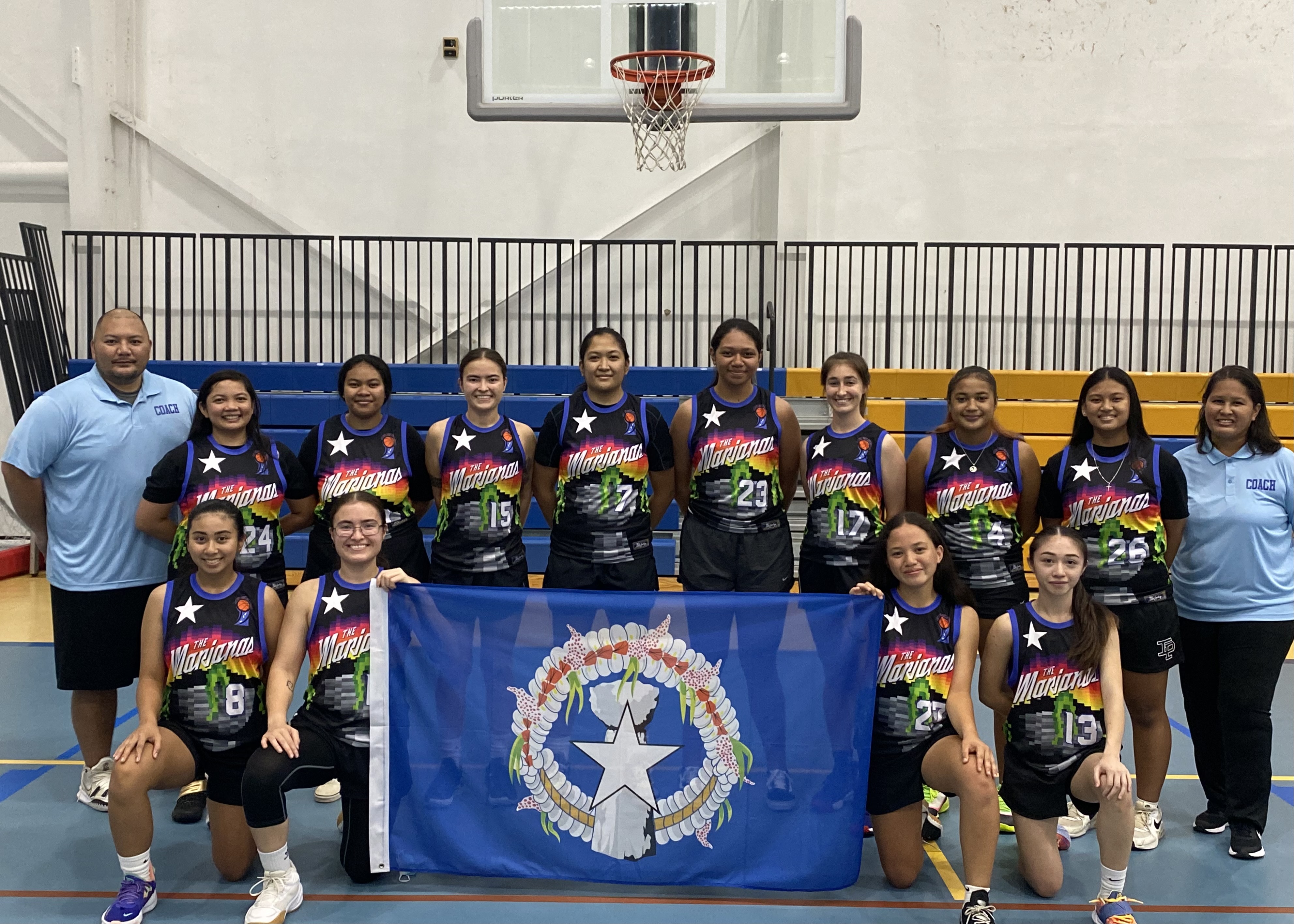 The NMI Senior National Program athletes pose for a group photo with coaches Catherine Attao-Toves, standing right, and David John Apatang, standing left, before a practice session at the Marianas High School gymnasium early this month.
