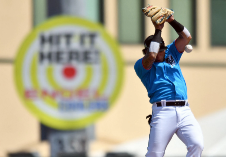 Miami Marlins second baseman Isan Diaz (1) knocks down a line drive in the sixth inning of a spring training game against the New York Mets at Roger Dean Stadium in Jupiter, Florida on March 21, 2022.