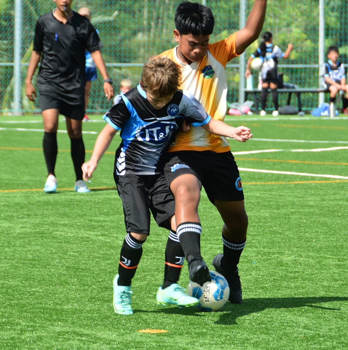 MPU 2's Quido Jambor and Kanoa 1's Jayson Tagabuel battle for the possession during a U13 youth league game at the NMI Soccer Training Center.