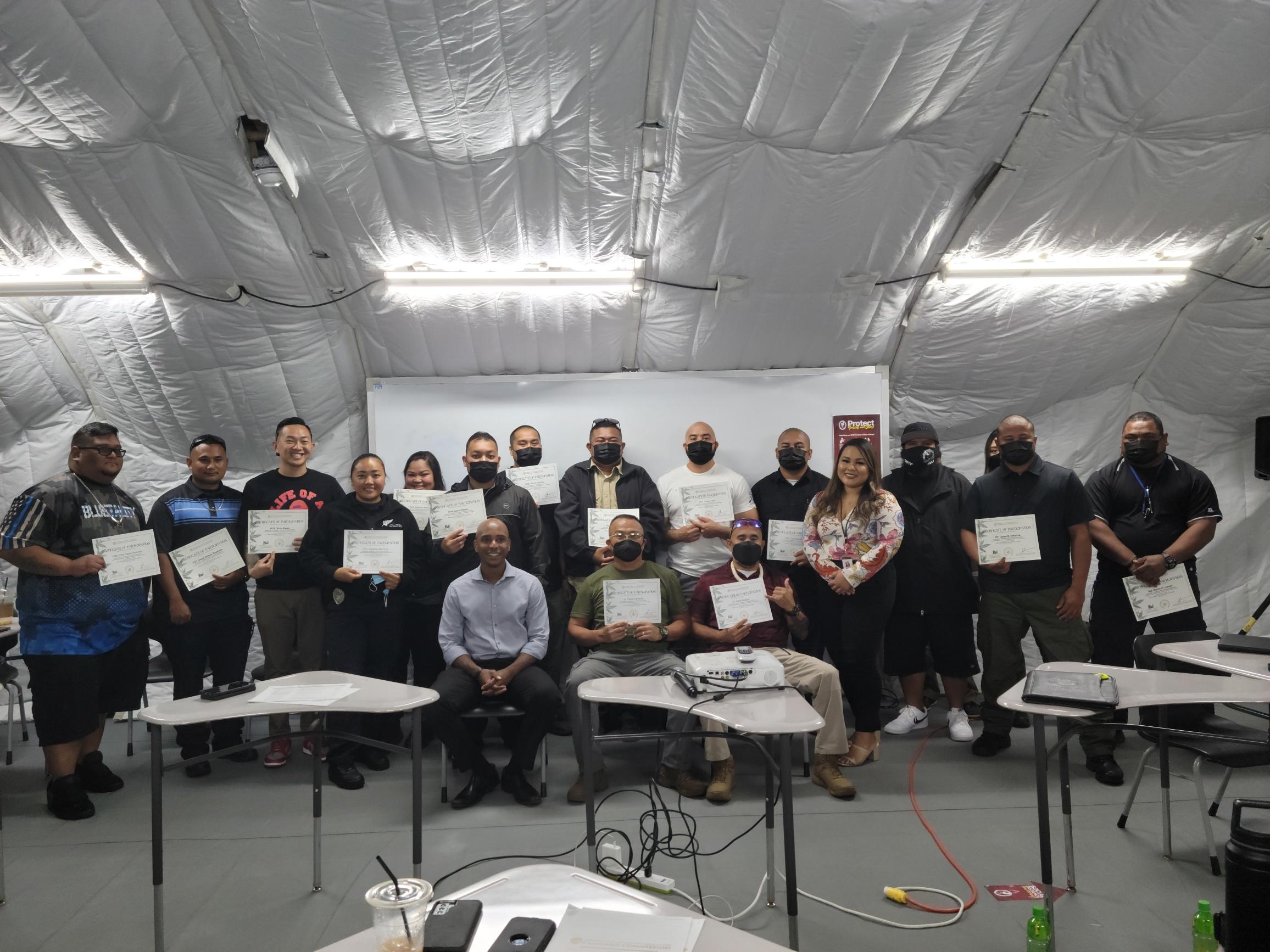 CNMI Cannabis Commission Managing Director Monique Boyer Sablan and Chief Prosecutor Chester Hinds pose for a photo with the Department of Public Safety officers who underwent law enforcement training on the Cannabis Act Friday at Northern Marianas College.