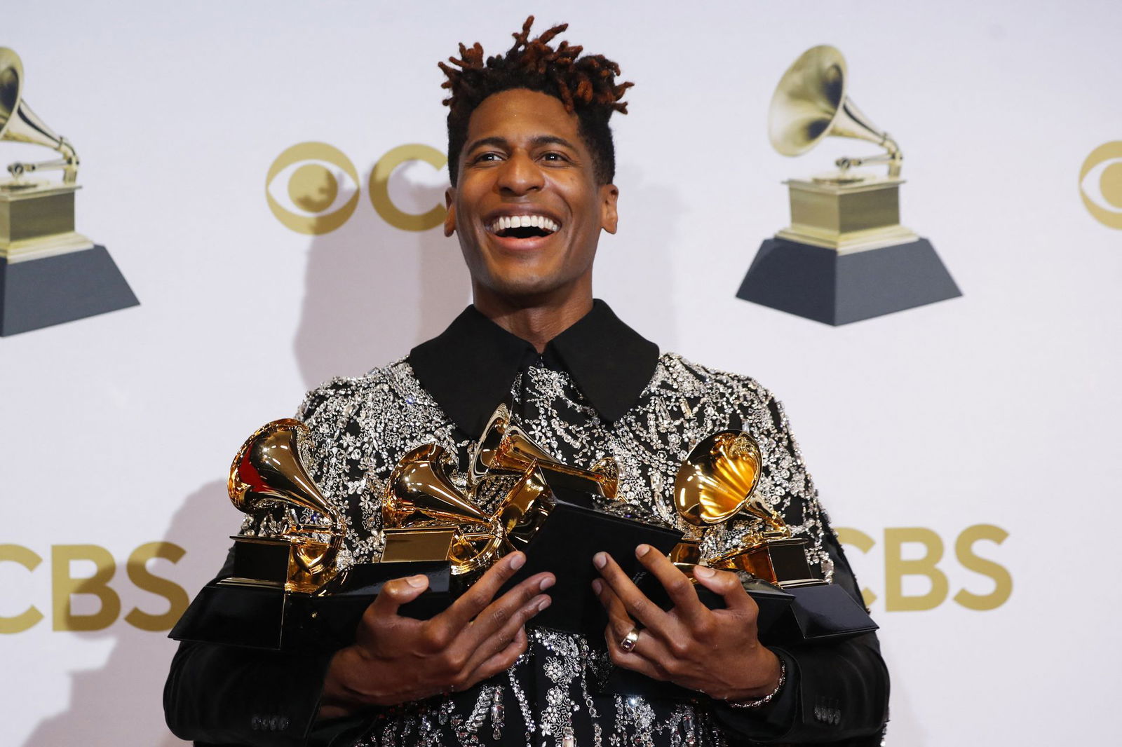 Jon Batiste poses with the Grammys for Best American Roots Performance for "Cry," Album of the year for “We Are,” Best American roots song, Best music video and Best score soundtrack for visual media for “Soul," at the 64th Annual Grammy Awards at the MGM Grand Garden Arena in Las Vegas, Nevada, April 3, 2022.