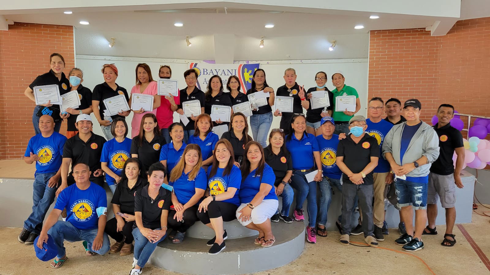 Bayani Association officers and members pose with LGBTQ+ hairdressers and barbers who provided free haircuts to community members at the Garapan Round House on Sunday.