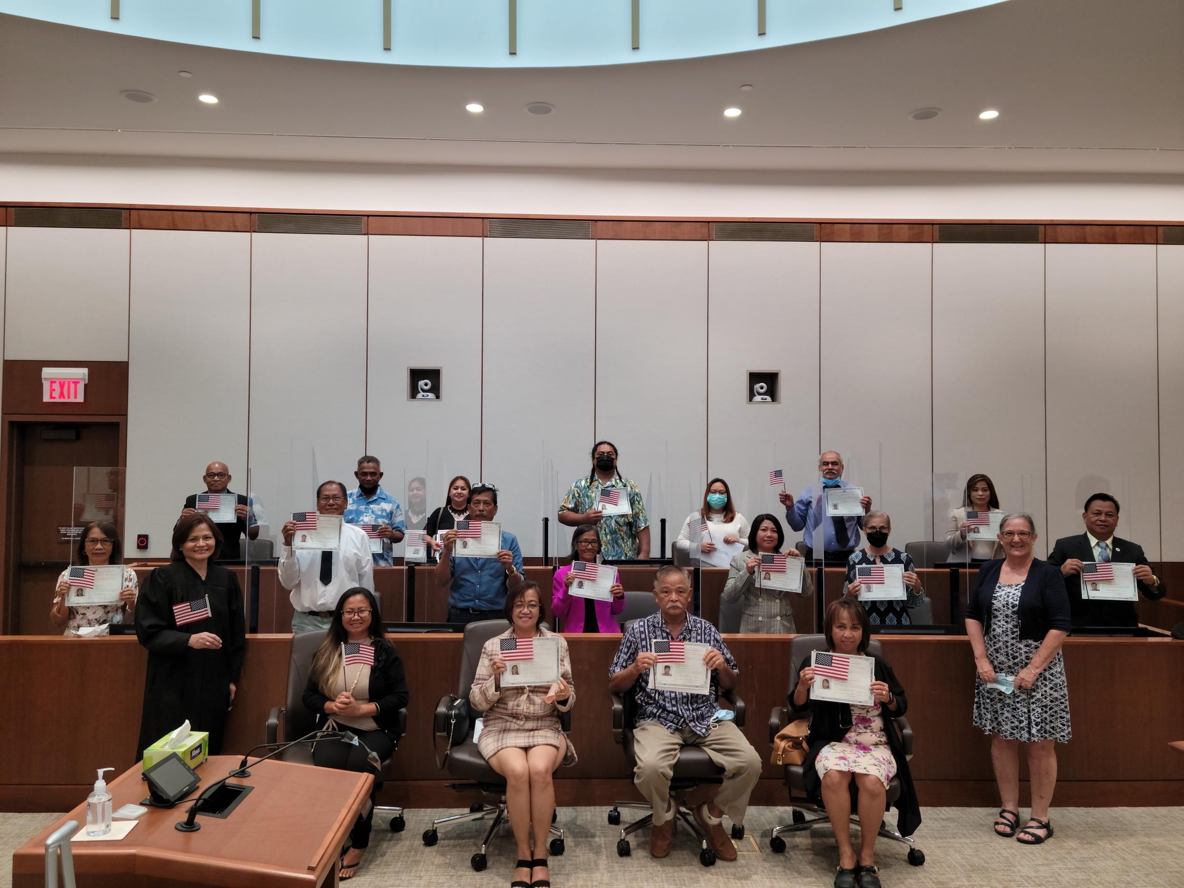 District Court for the NMI Chief Judge Ramona V. Manglona  and Patricia Phelan, U.S. Citizenship and Immigrations Services officer, pose for a photo with the newly sworn in U.S. citizens at the U.S. courthouse Monday.