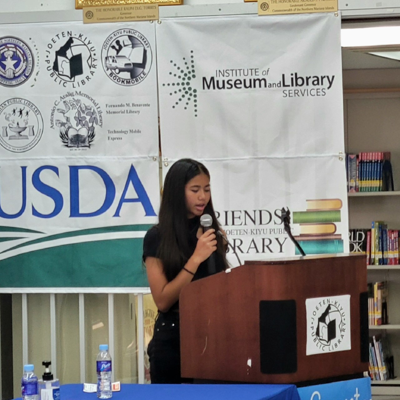 Vaniqa T. Torres of Grace Christian Academy reads the proclamation for National Library Workers Day.