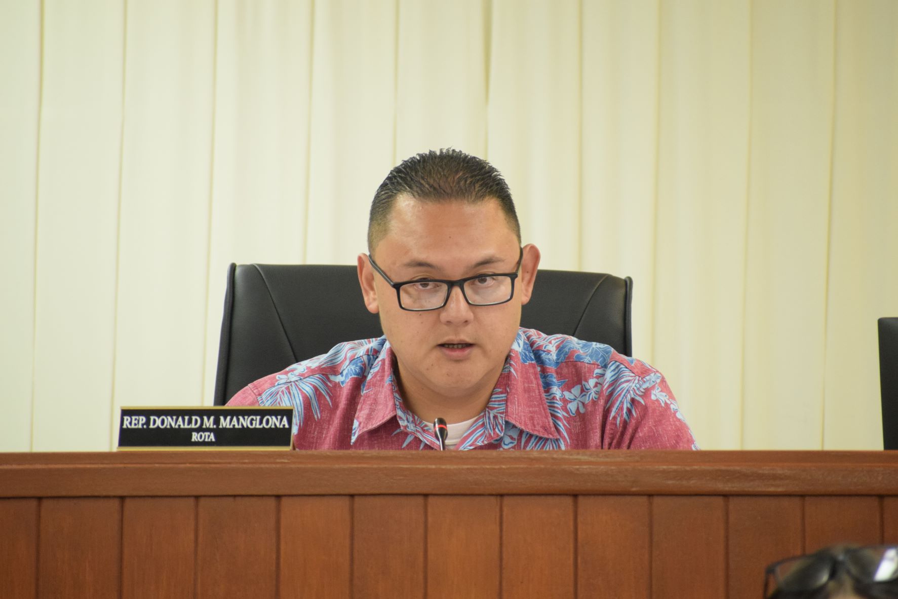 Rep. Donald Manglona,  as acting House floor leader, moves for the passage of the retiree-bonus bill during a House session on Wednesday.