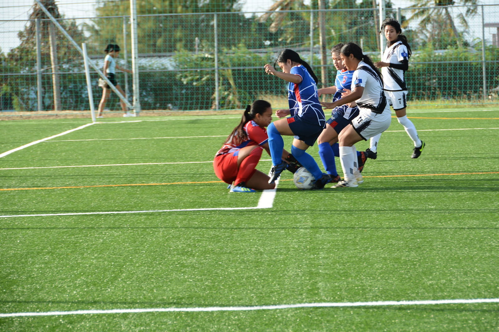 Southern United and Shirley's football player scramble for the loose ball during a U16 Girls division game Saturday of the TakeCare Youth Soccer League at the NMI Soccer Training Center.
