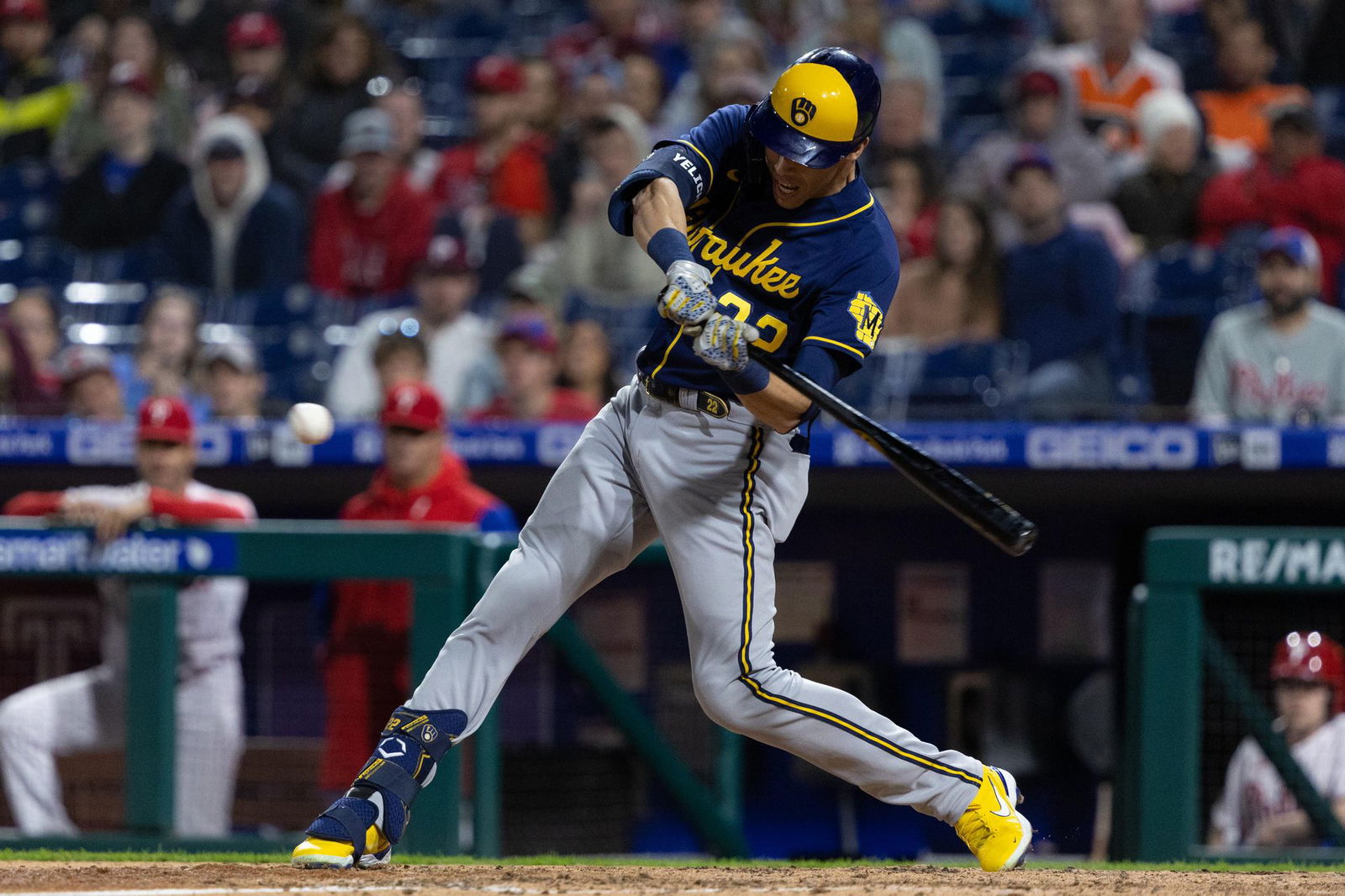 Milwaukee Brewers left fielder Christian Yelich (22) hits an RBI sacrifice fly during the ninth inning against the Philadelphia Phillies at Citizens Bank Park in Philadelphia, Pennsylvania on April 24, 2022.