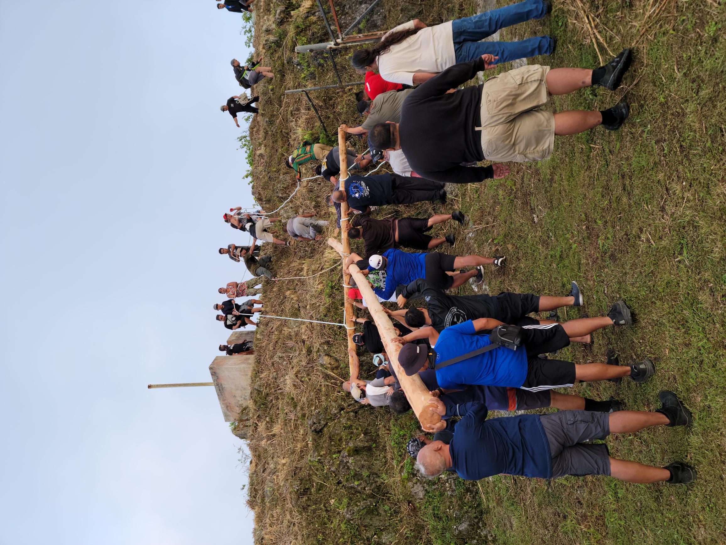 Devotees carrying a wooden cross approach the island’s highest point on Good Friday.