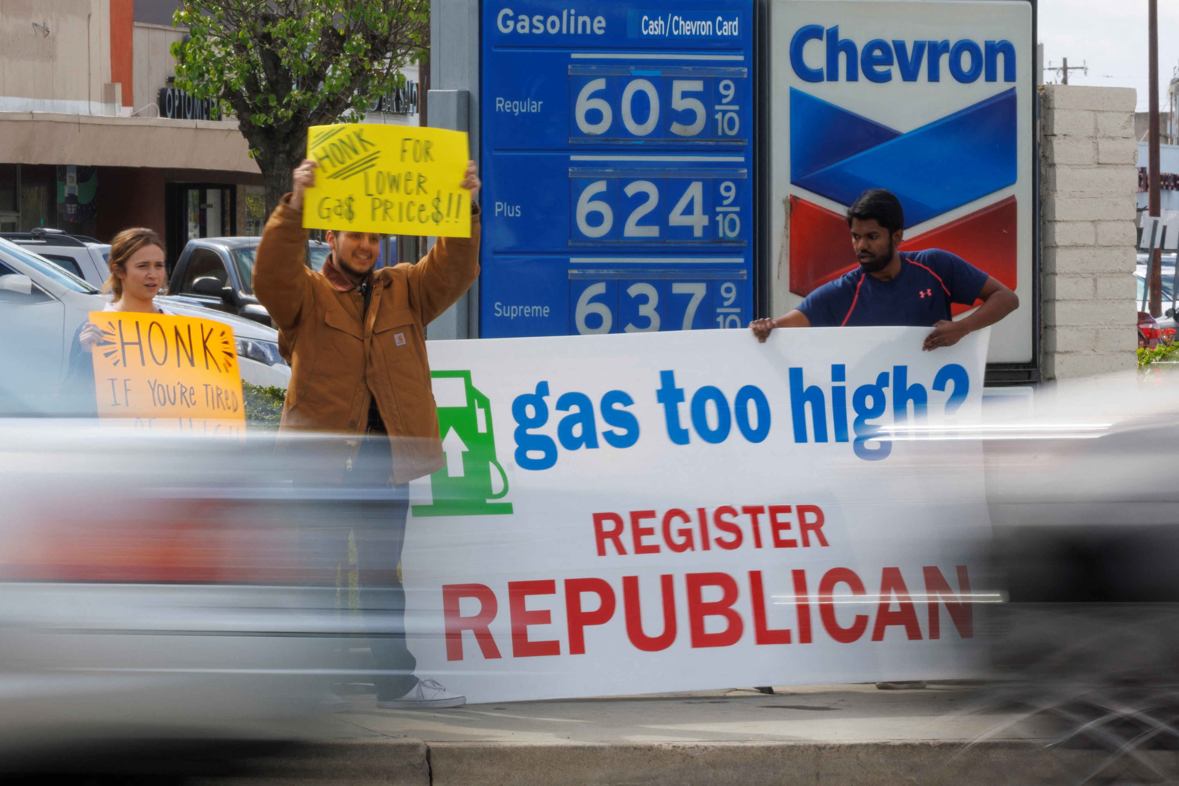 Republican activists approach people filling up their cars, as fuel prices rise, hoping to register them to vote for their party in Garden Grove, California, March 29, 2022.