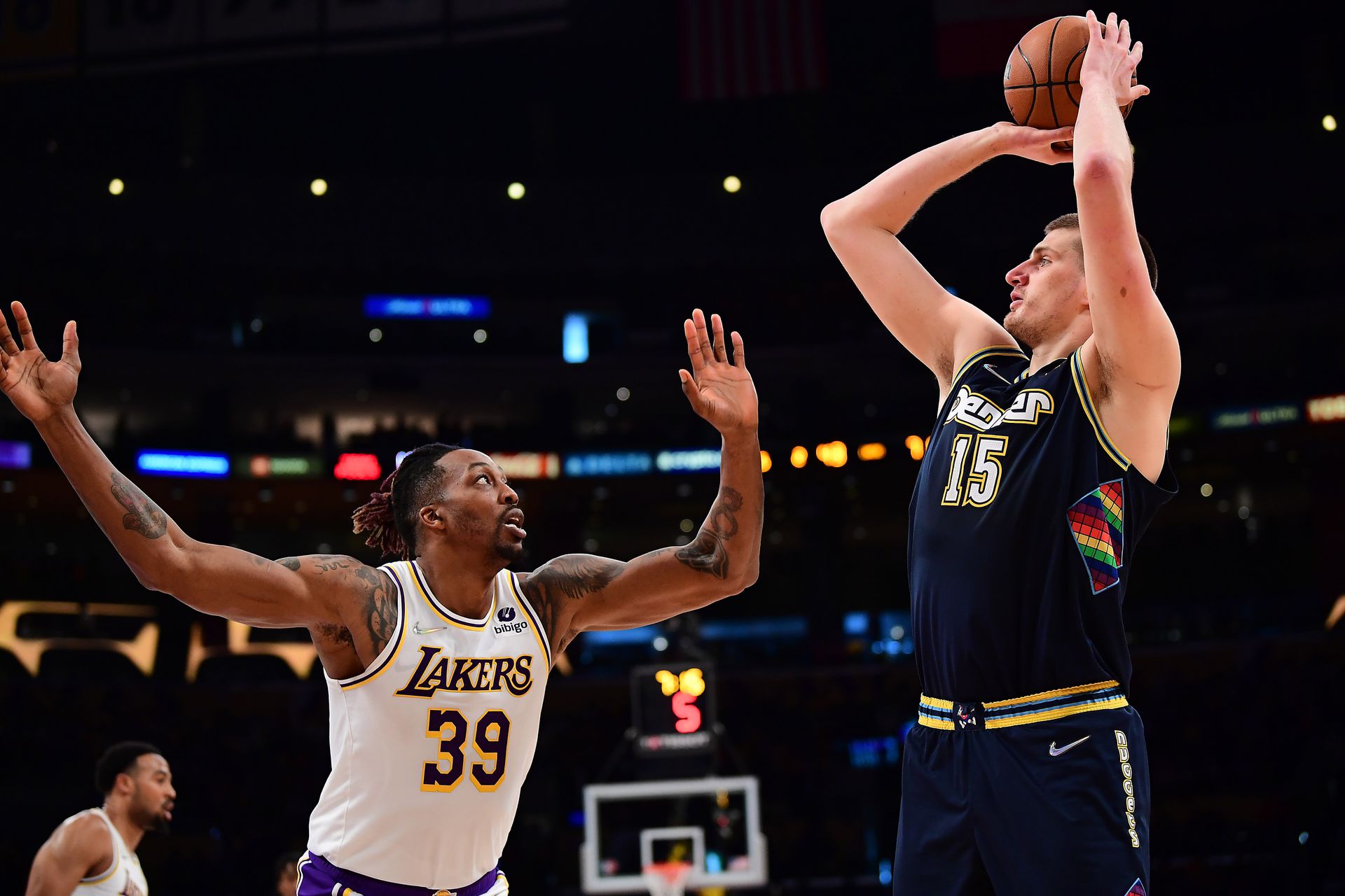 Denver Nuggets center Nikola Jokic (15) shoots against Los Angeles Lakers center Dwight Howard (39) during the first half at Crypto.com Arena in Los Angeles, California on April 3, 2022.